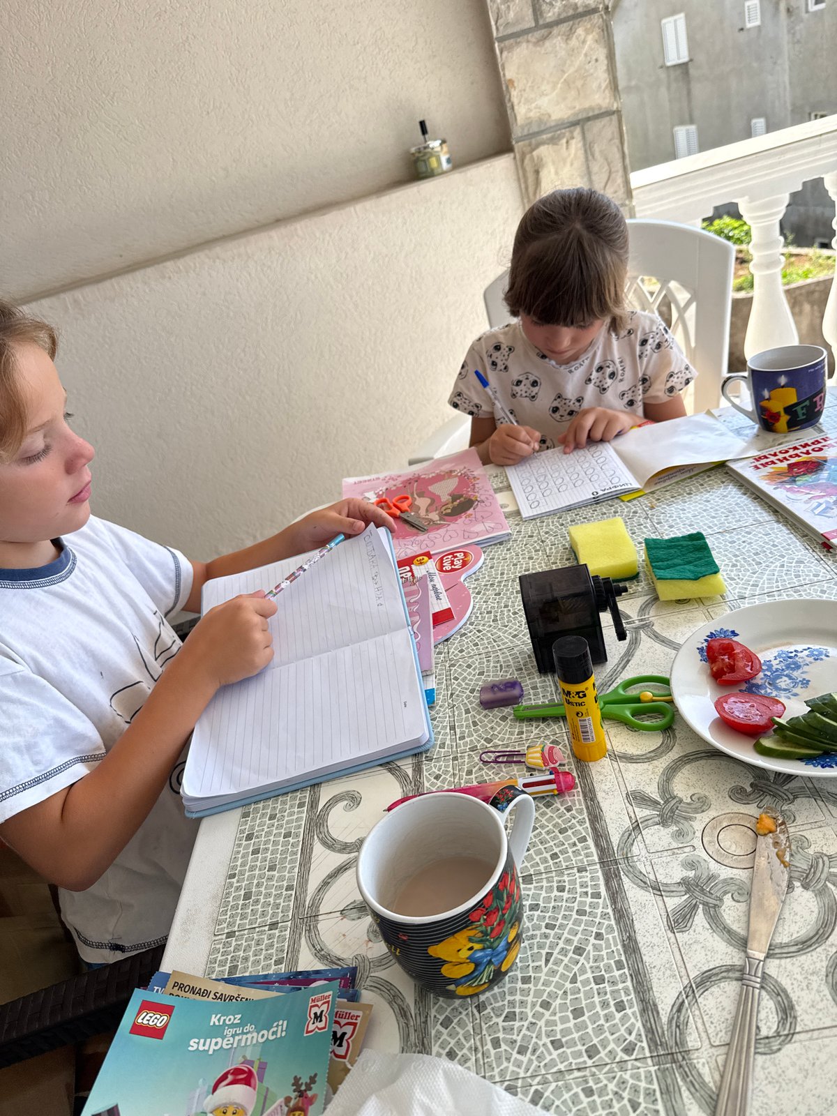 Morning moments captured in Bijela: children drawing, woman photographed