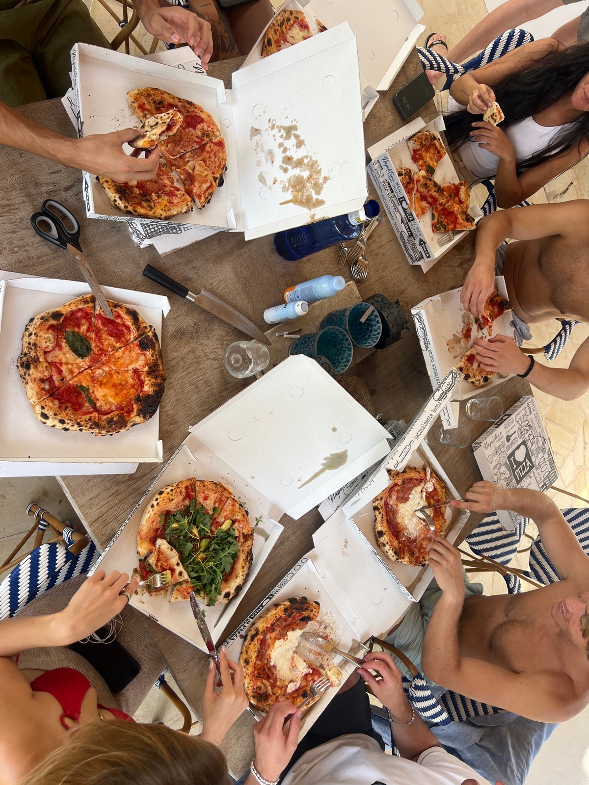 Outdoor pizza lunch on a rustic patio in Spain
