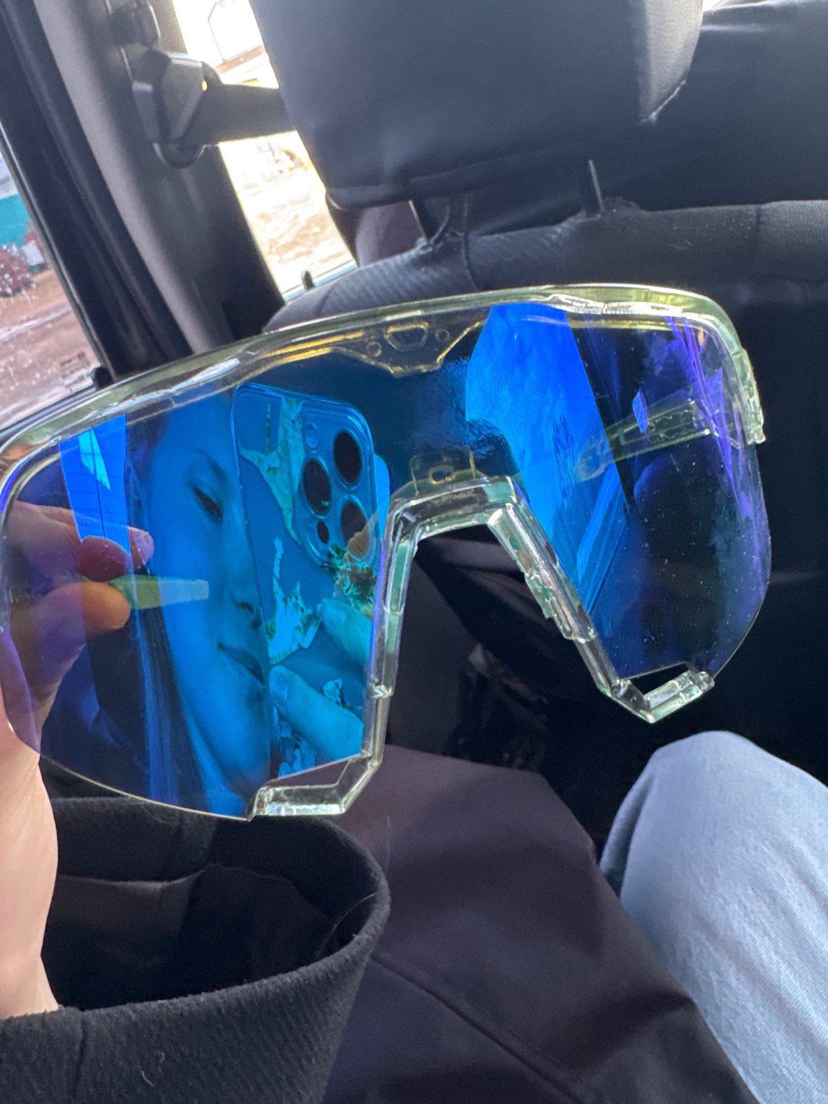 Woman with sunglasses photographed in car backseat in Russia