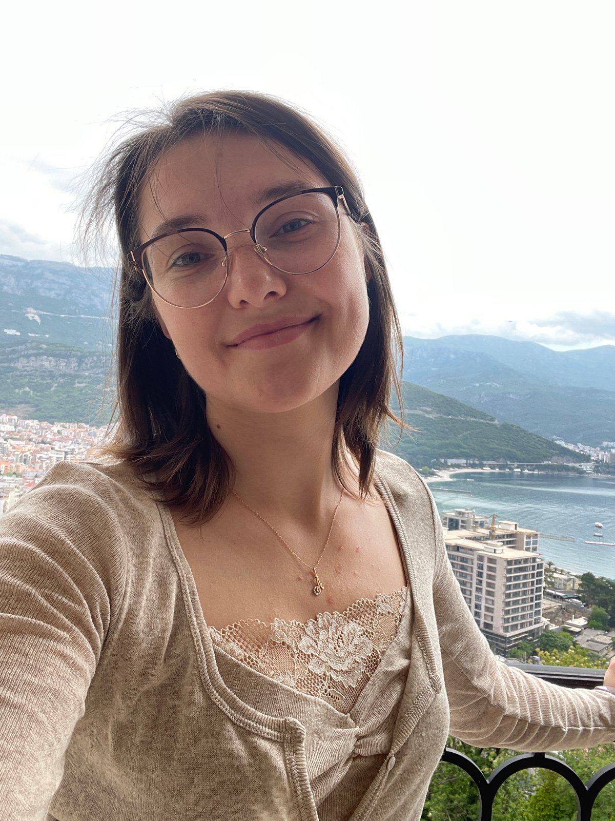 Woman photographed on balcony overlooking Budva coastal views