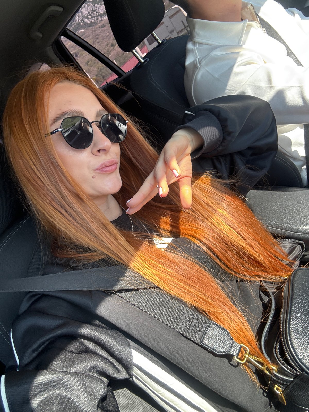 Woman in sunglasses spotted in car passenger seat, Montenegro