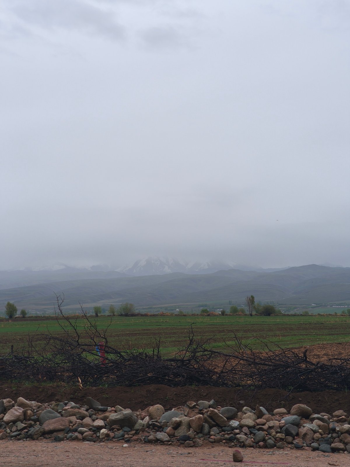 Overcast skies observed over rural Kyrgyzstan countryside