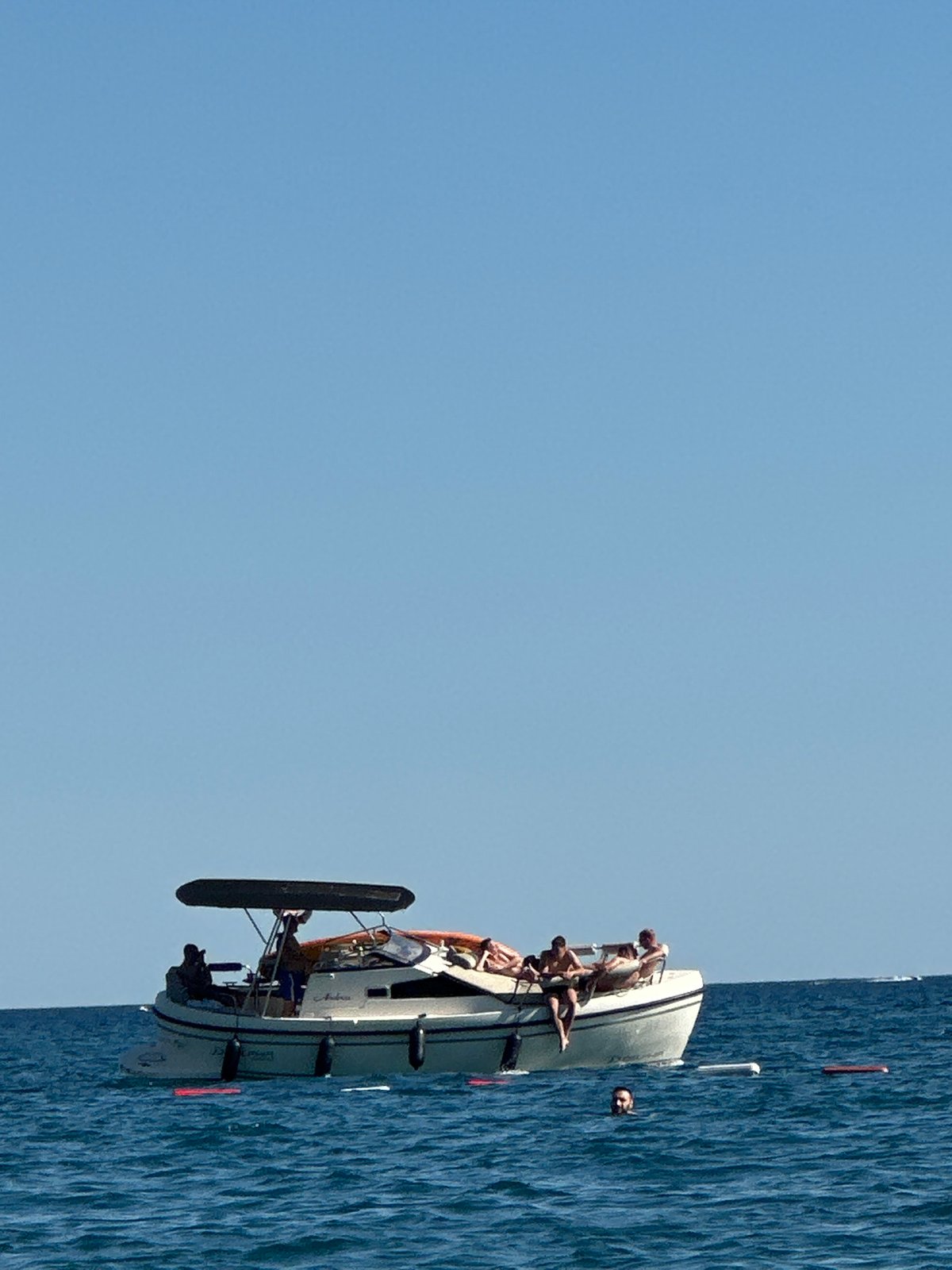 Boats and day-trippers on the Adriatic near Boreti, Montenegro