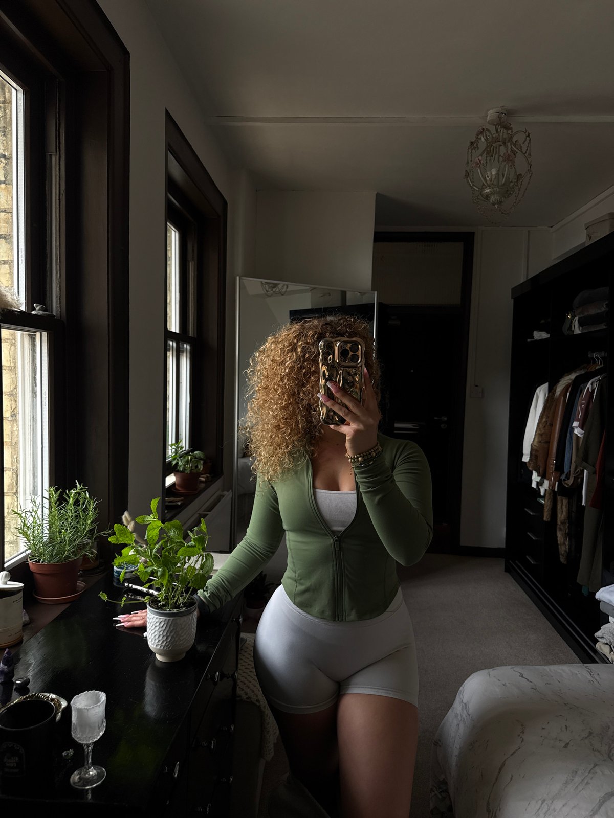 Woman documents plant care and green smoothie in London bedroom