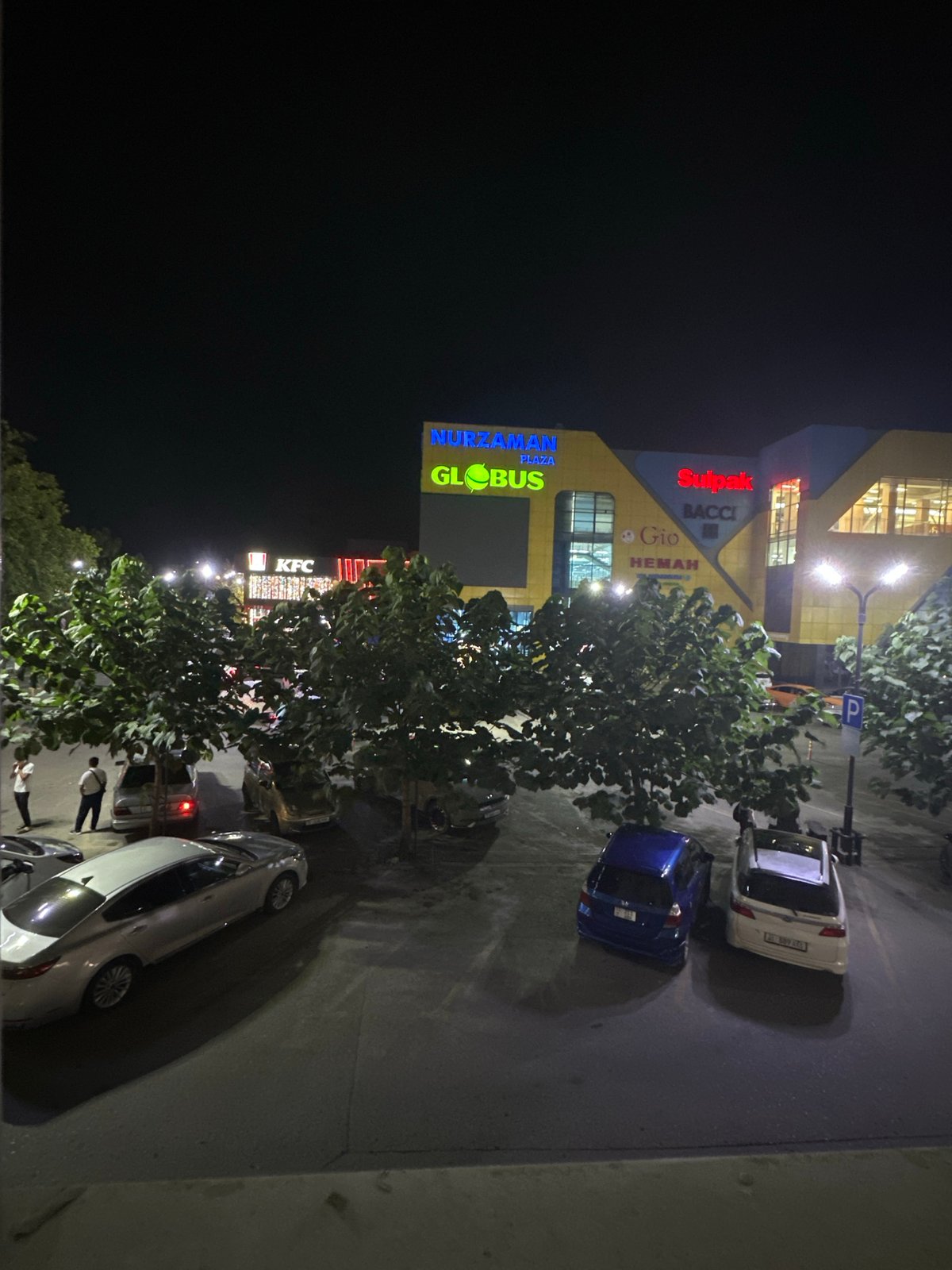 Osh City storefront lights up alongside abstract digital patterns