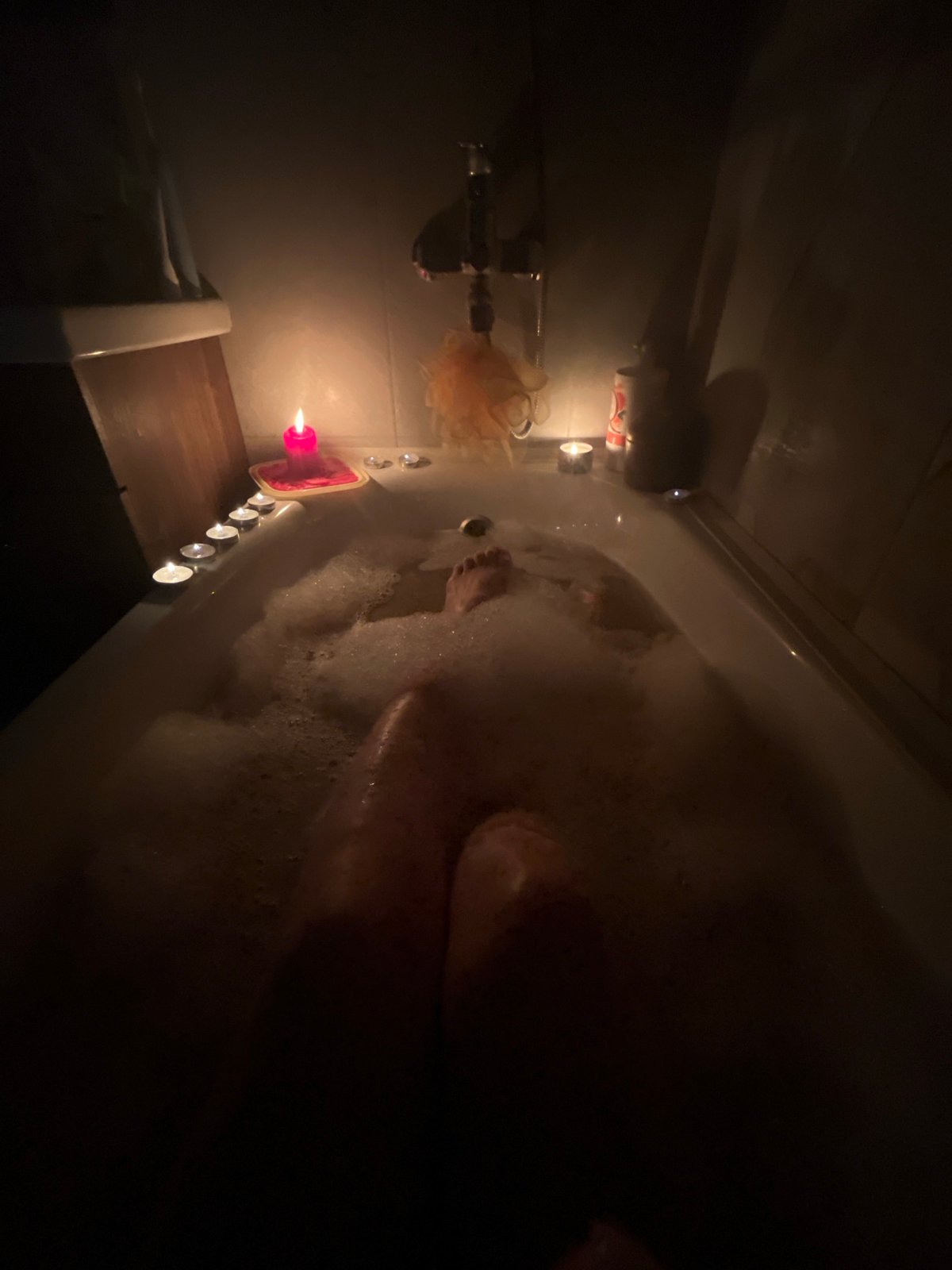 Candlelit bubble bath session documented in Kazan bathroom