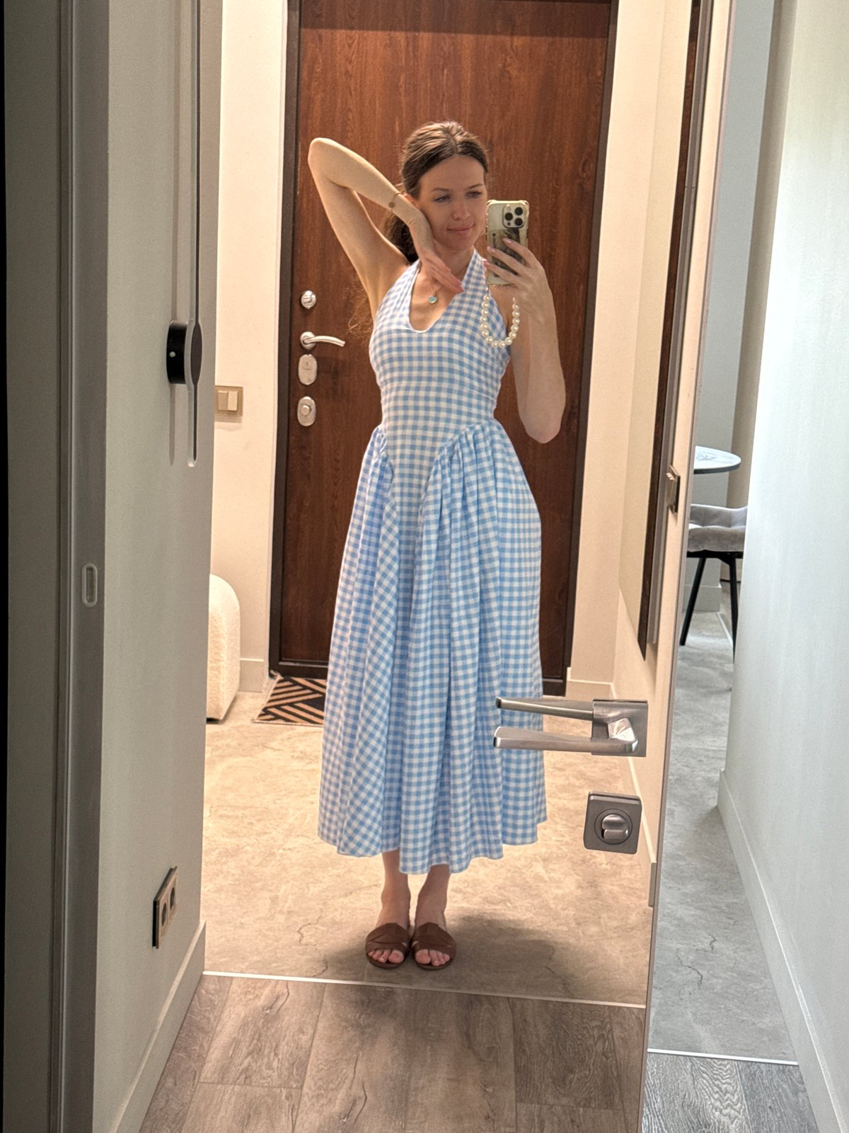 Woman takes multiple selfies in Dolgoprudny, Russia indoor setting