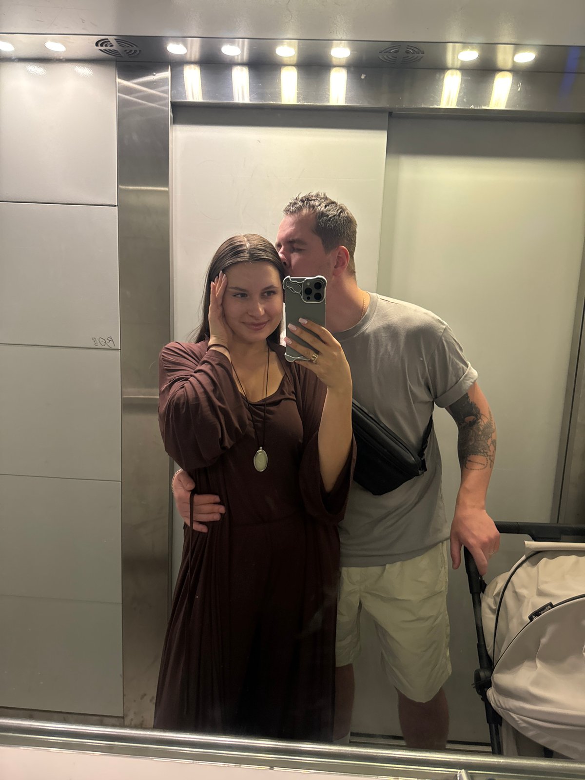 Couple with stroller photographed in elevator in Odintsovo
