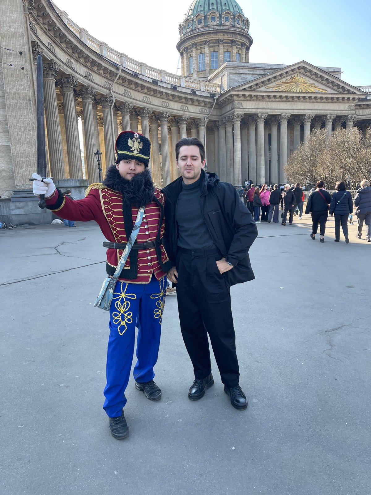 Tourists photograph costumed performers, landmarks in Saint Petersburg
