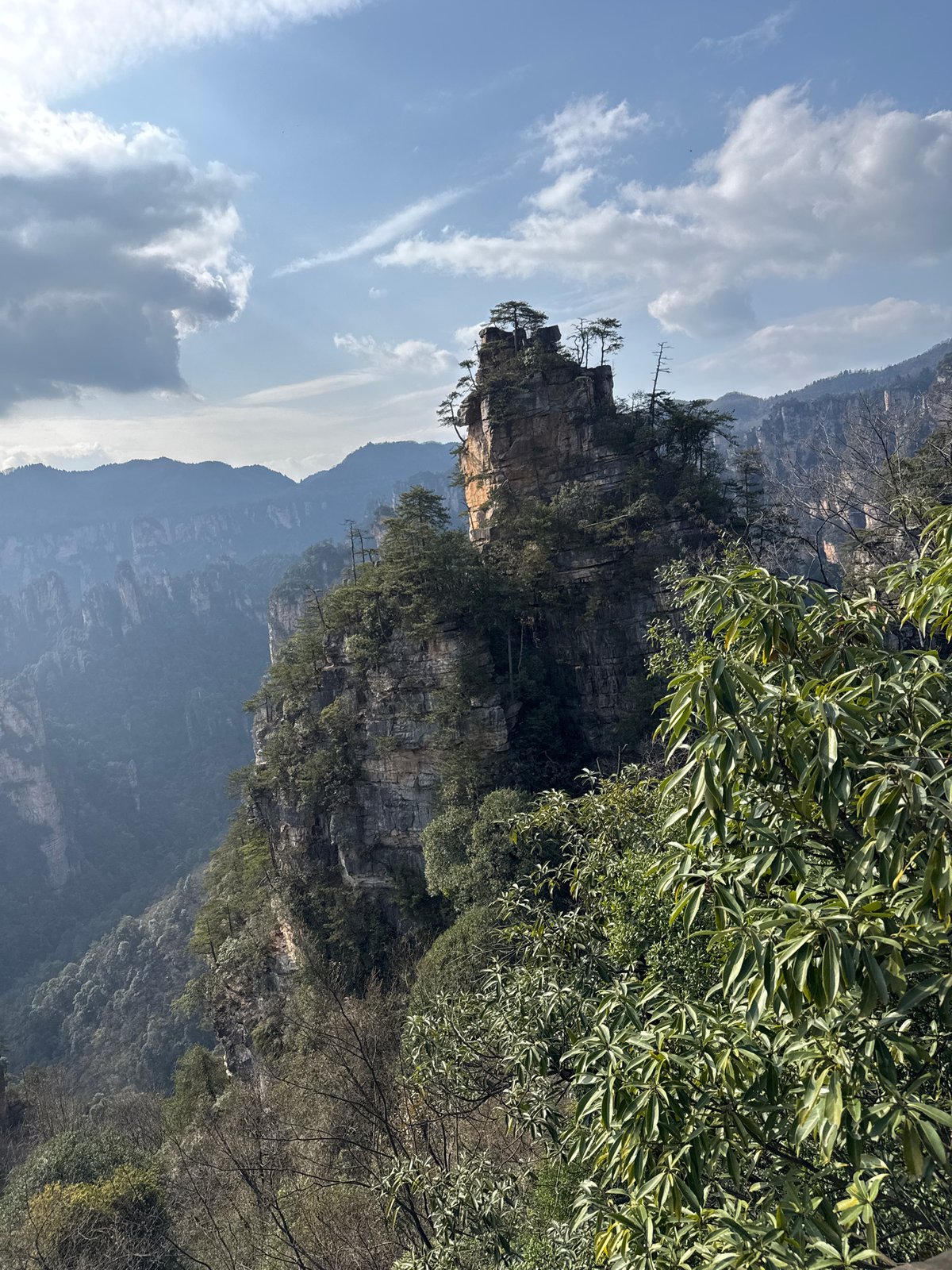 Tourists explore Wulingyuan's iconic sandstone landscapes and forest trails