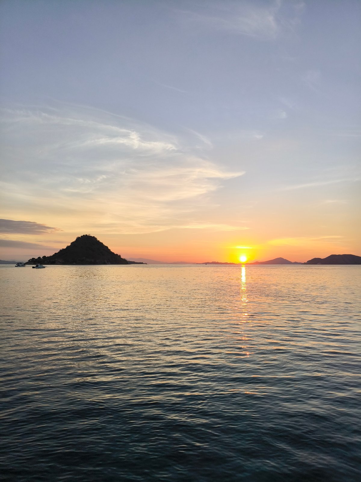 Reef sharks and a golden sunset off the Indonesian coast
