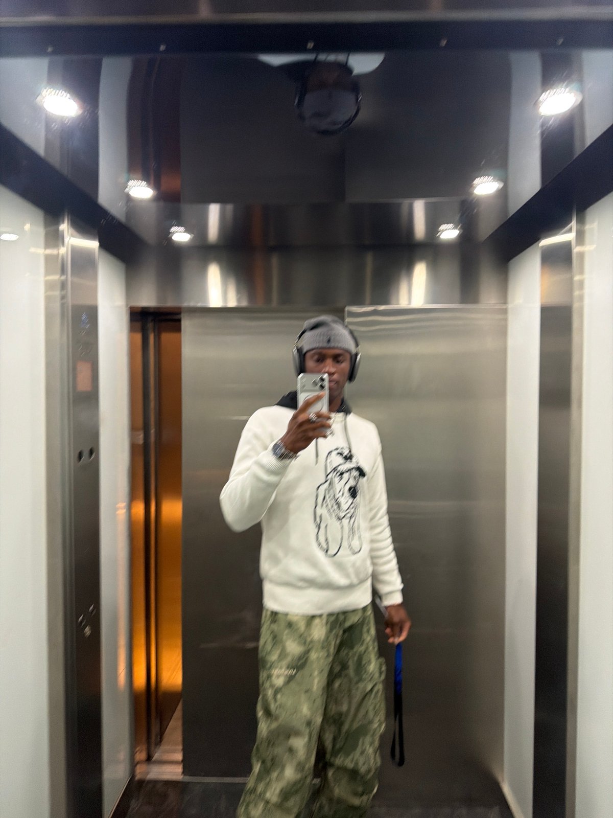Person takes mirror selfie in London elevator