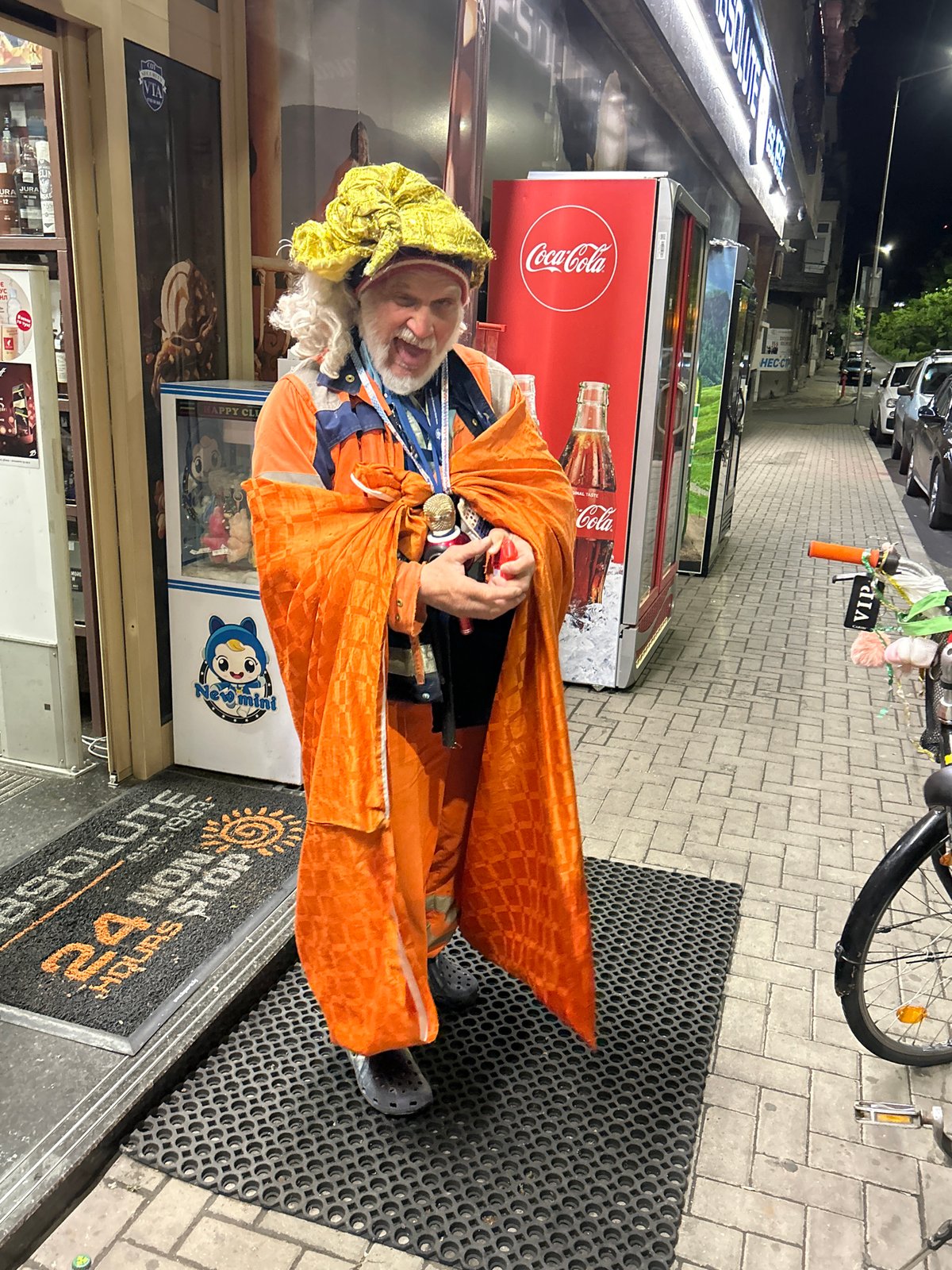 Orange-costumed figure spotted across multiple city locations during evening