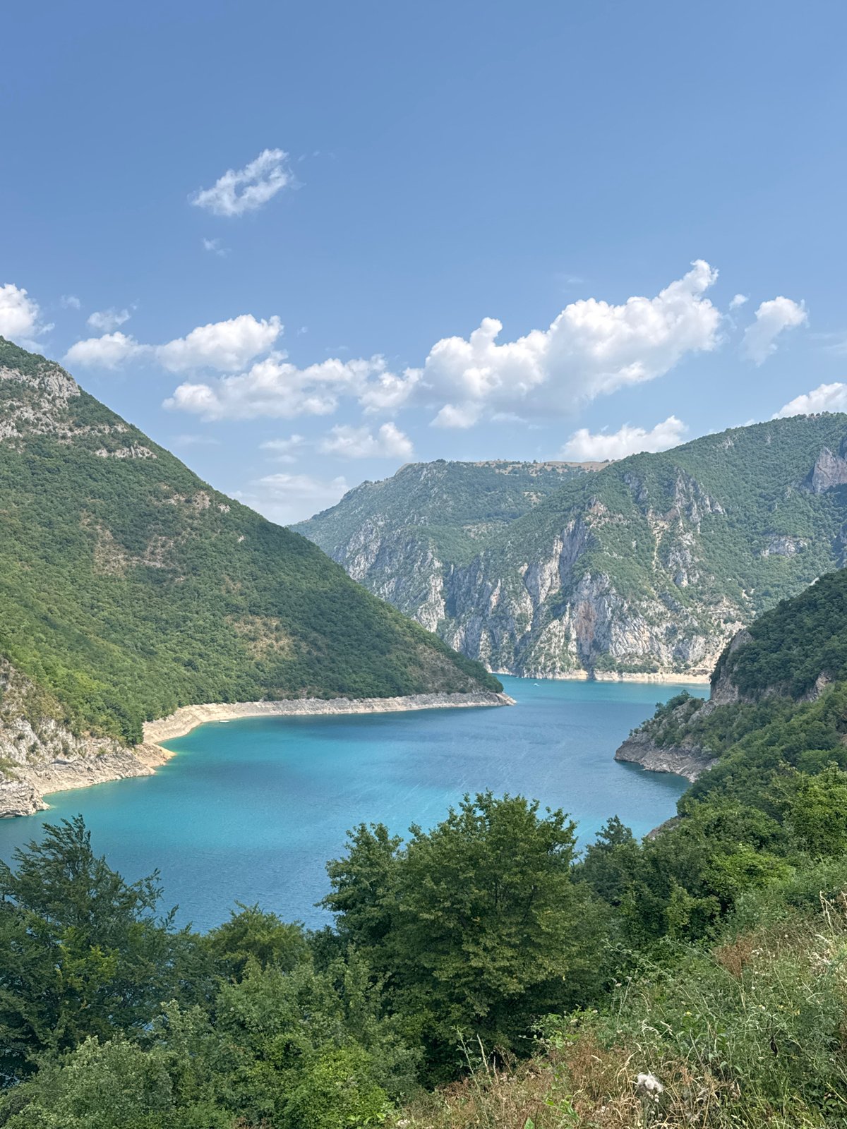 A morning on Piva Lake — boats, zip-lines, and canyon views