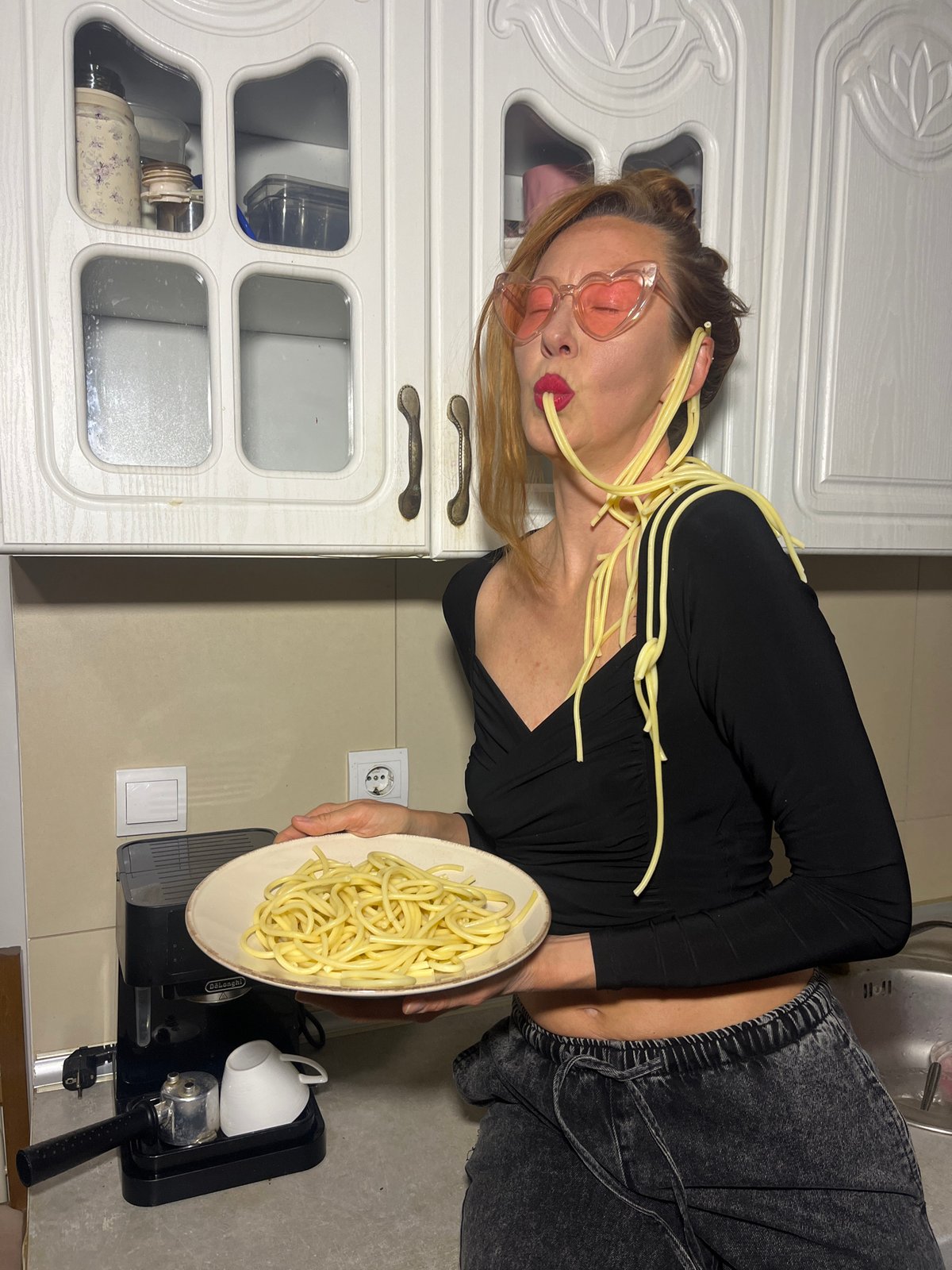 Woman photographs dessert spread in Budva kitchen