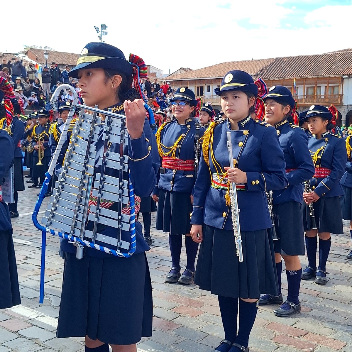 Youth marching band parades through historic Cuzco streets