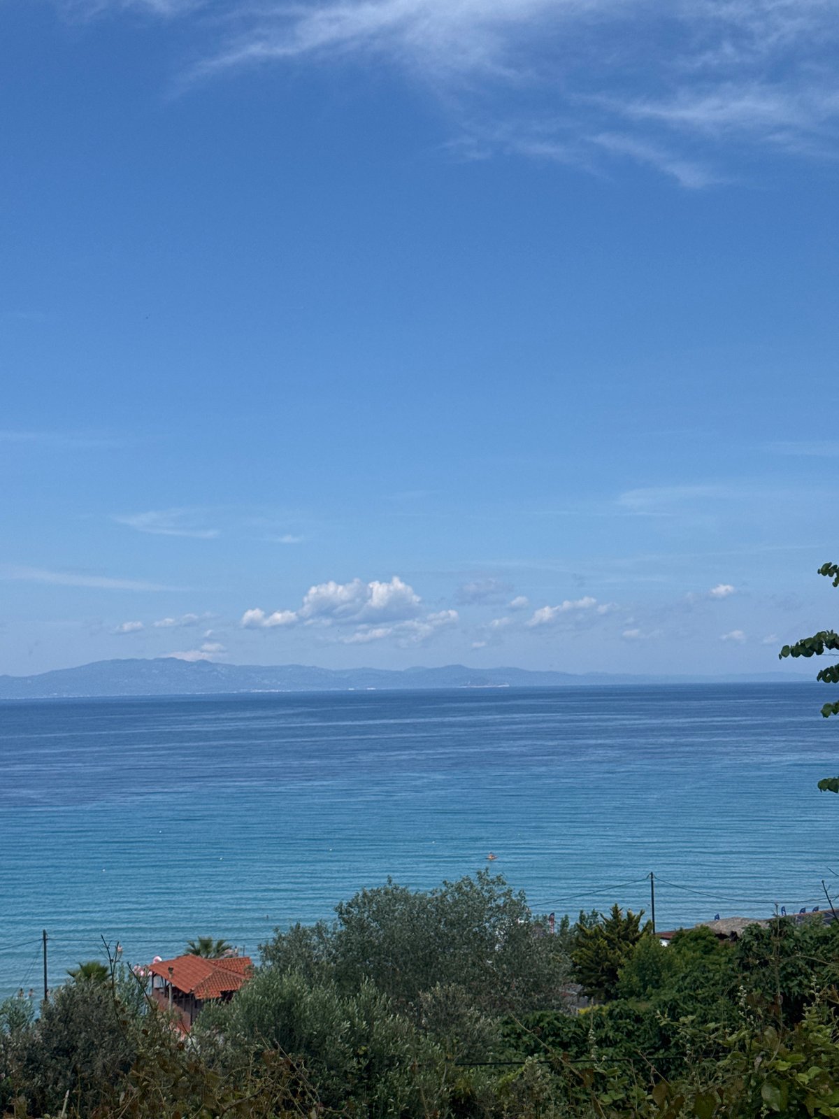 Beach crowds gather in Kassandra with stage setup