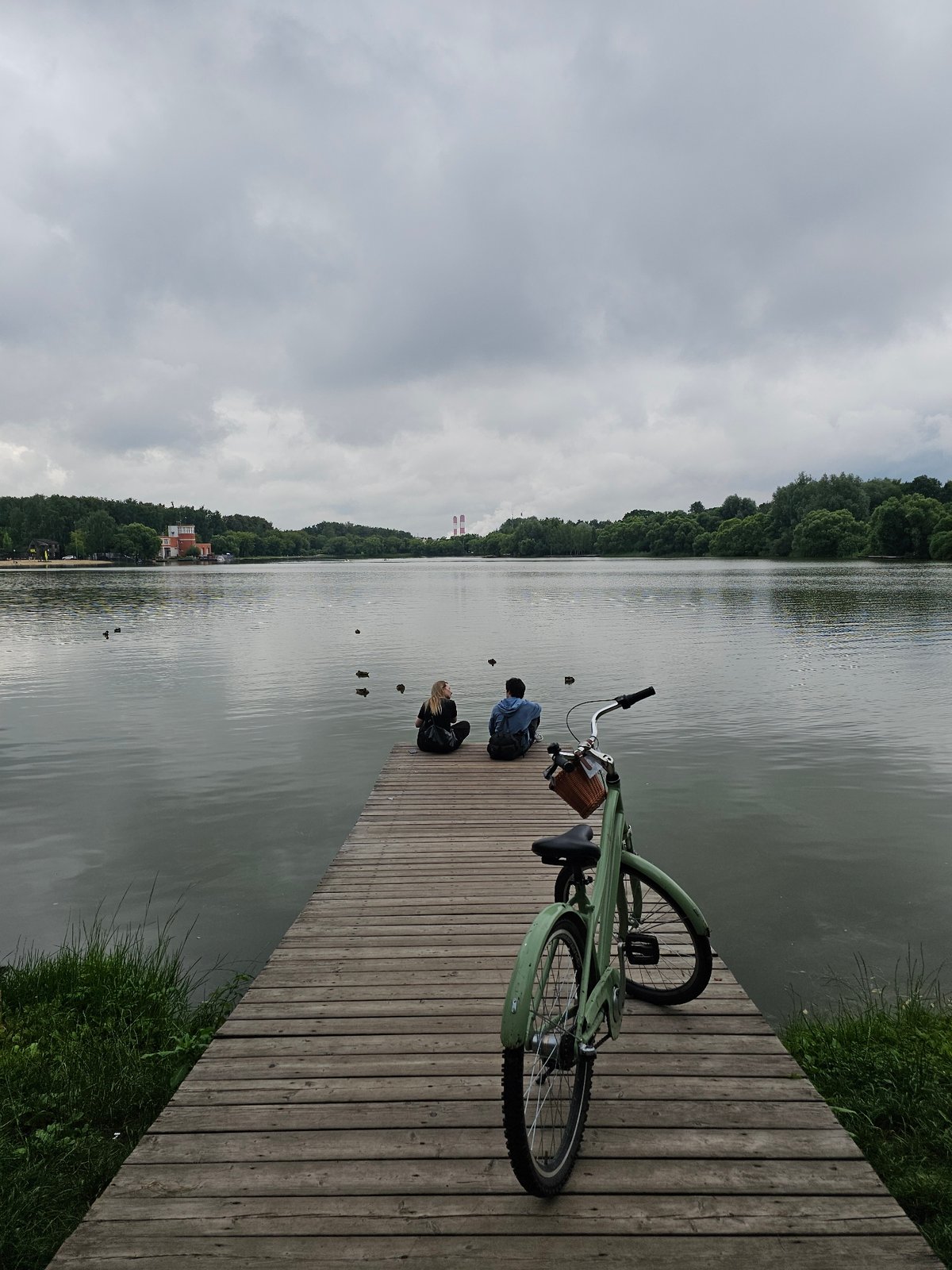 Stillness on a Moscow lake pier on a cloudy afternoon