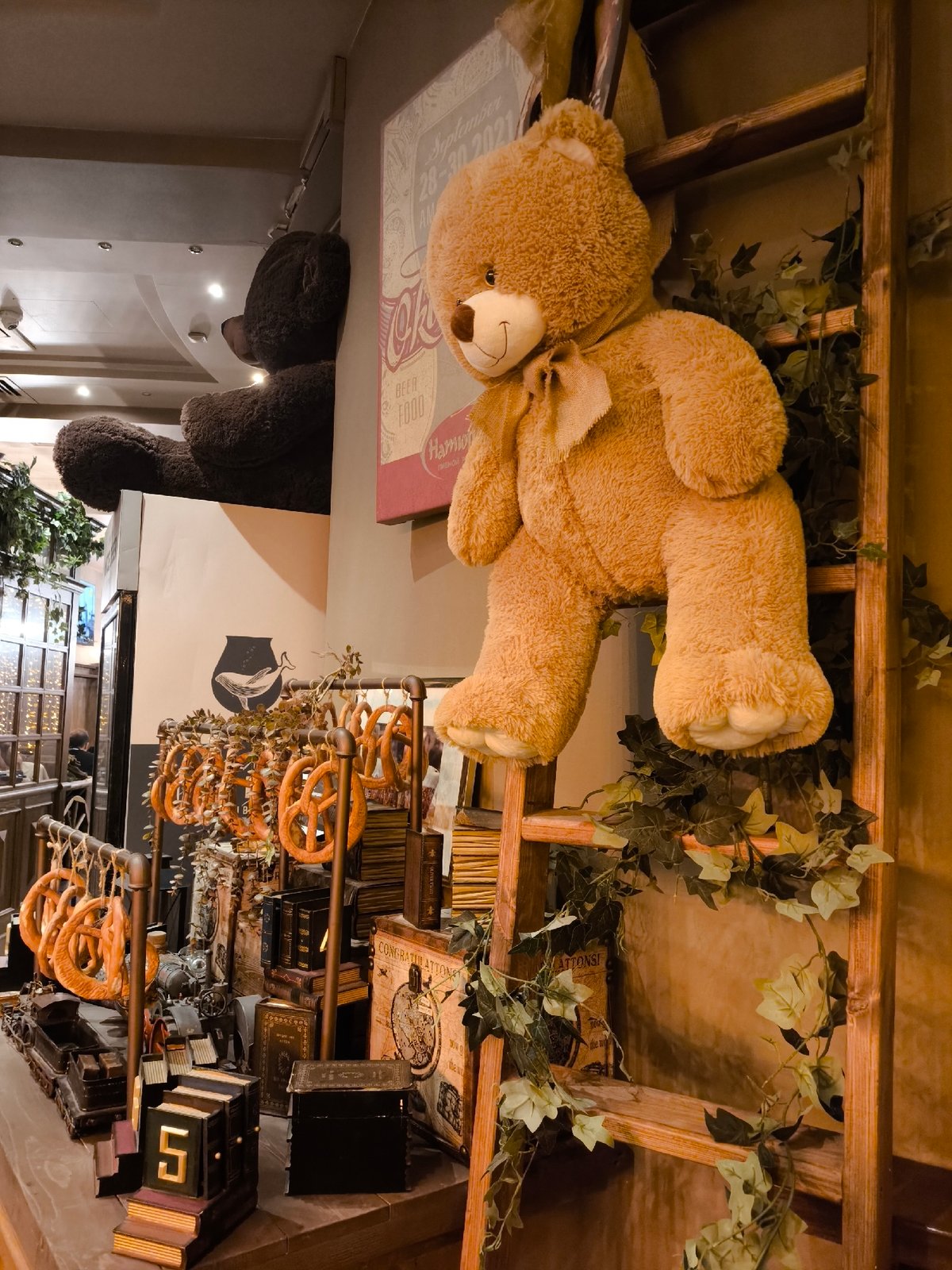 Cozy interior details: vintage trains, a bear display, and backlit glass
