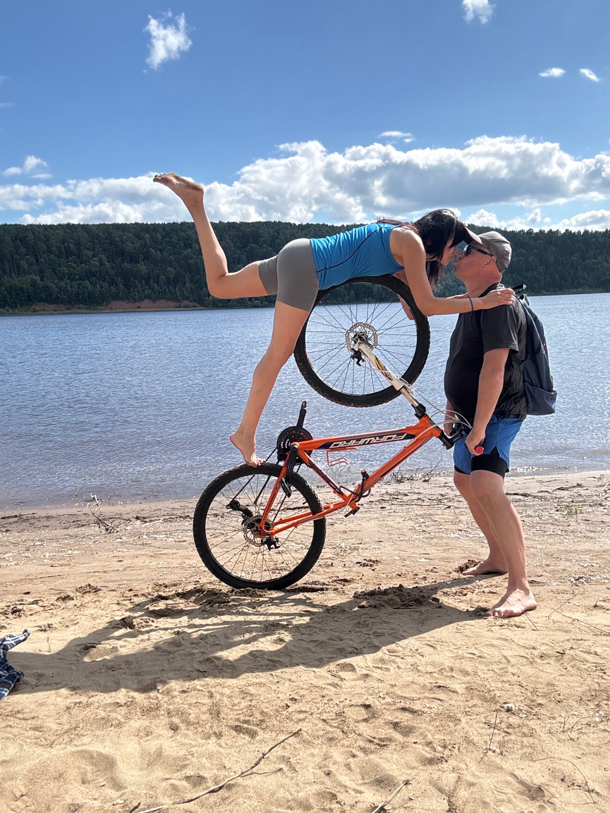 Couple enjoys beach bicycle activities in Ol'khovskoye, Russia