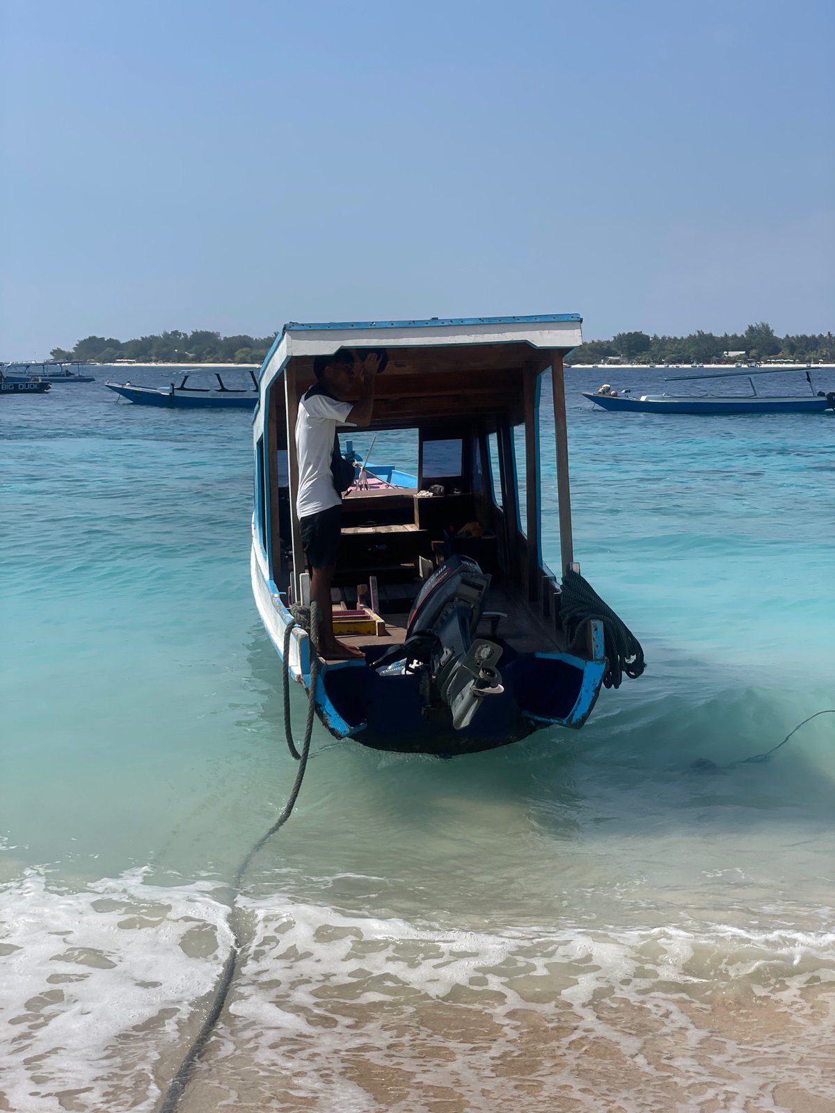 Lazy morning on Gili Trawangan's beach, boats and sun loungers out