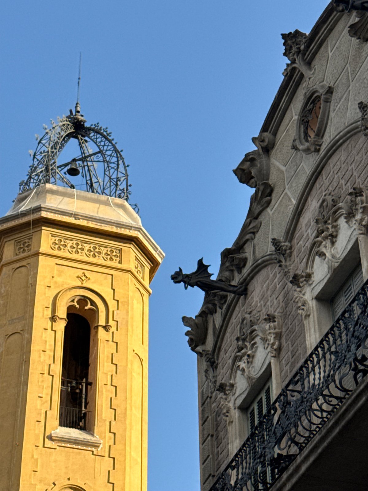 Tourist photographs Barcelona's historic architecture from street level