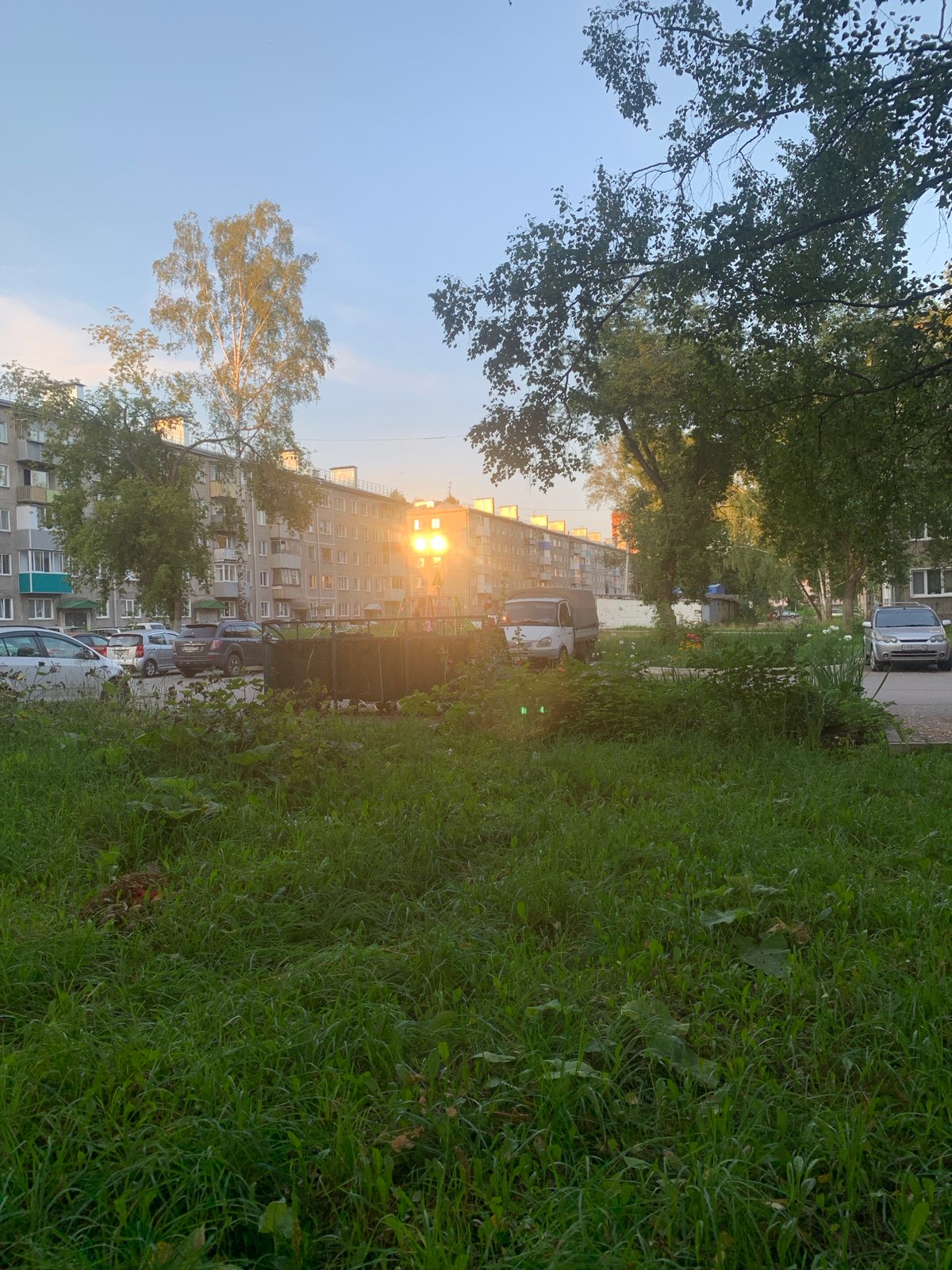 Summer afternoon in Prokopyevsk: flowerbeds, park paths, residential streets