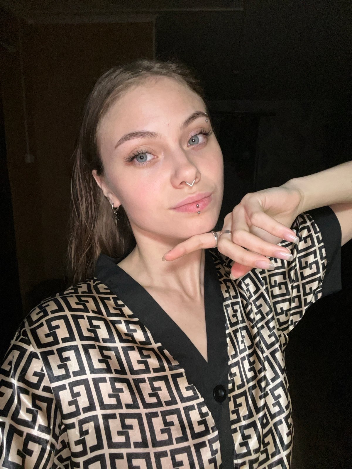 Woman with facial piercings photographed indoors in Foki, Russia