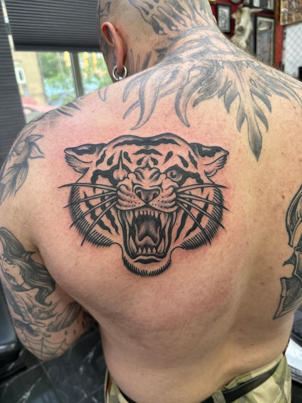 Fresh tattoo work completed in Moscow featuring tiger, sun designs