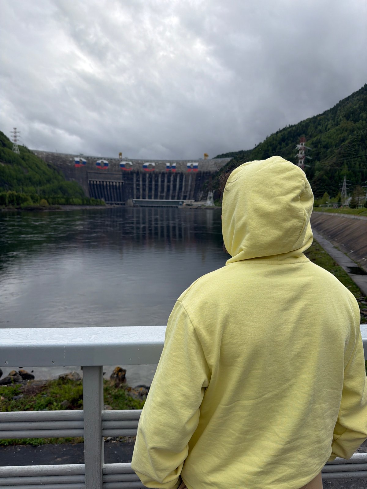 Visitor observes Sayano-Shushenskaya Dam from multiple viewpoints in Russia