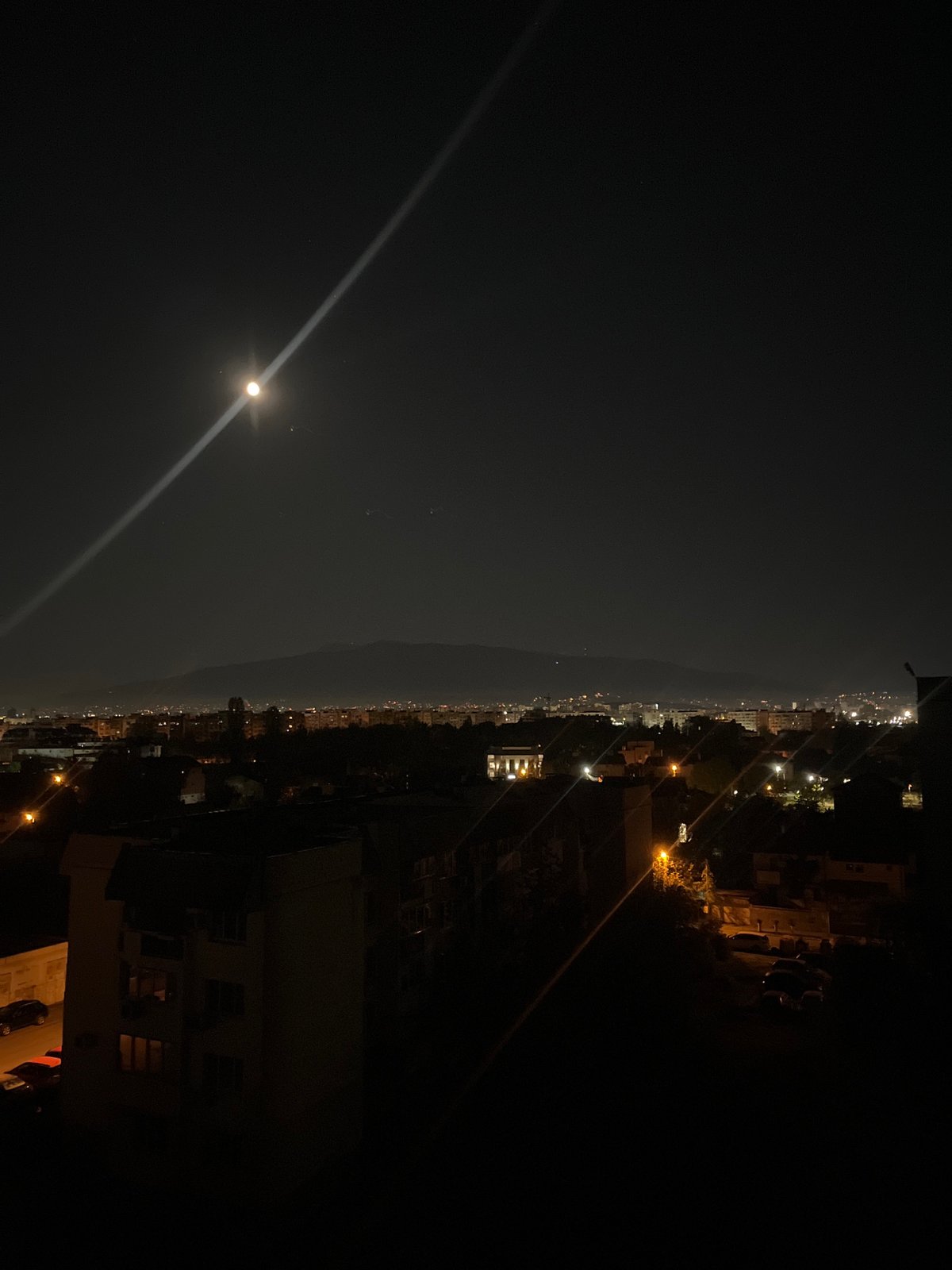 Sofia residents capture nighttime cityscape under moonlit sky