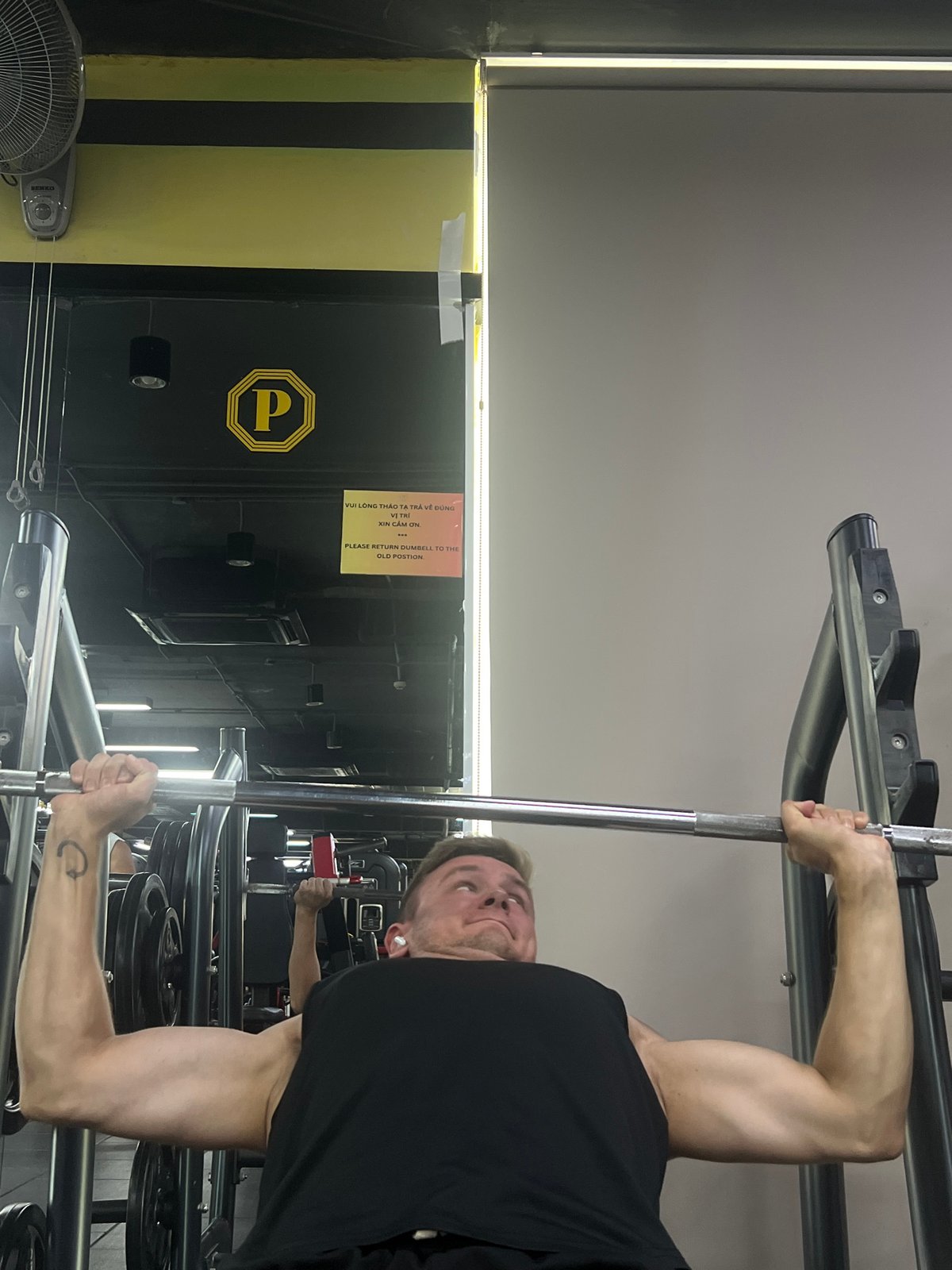 Gym-goer performs inverted pull-ups in Nam Nha Trang