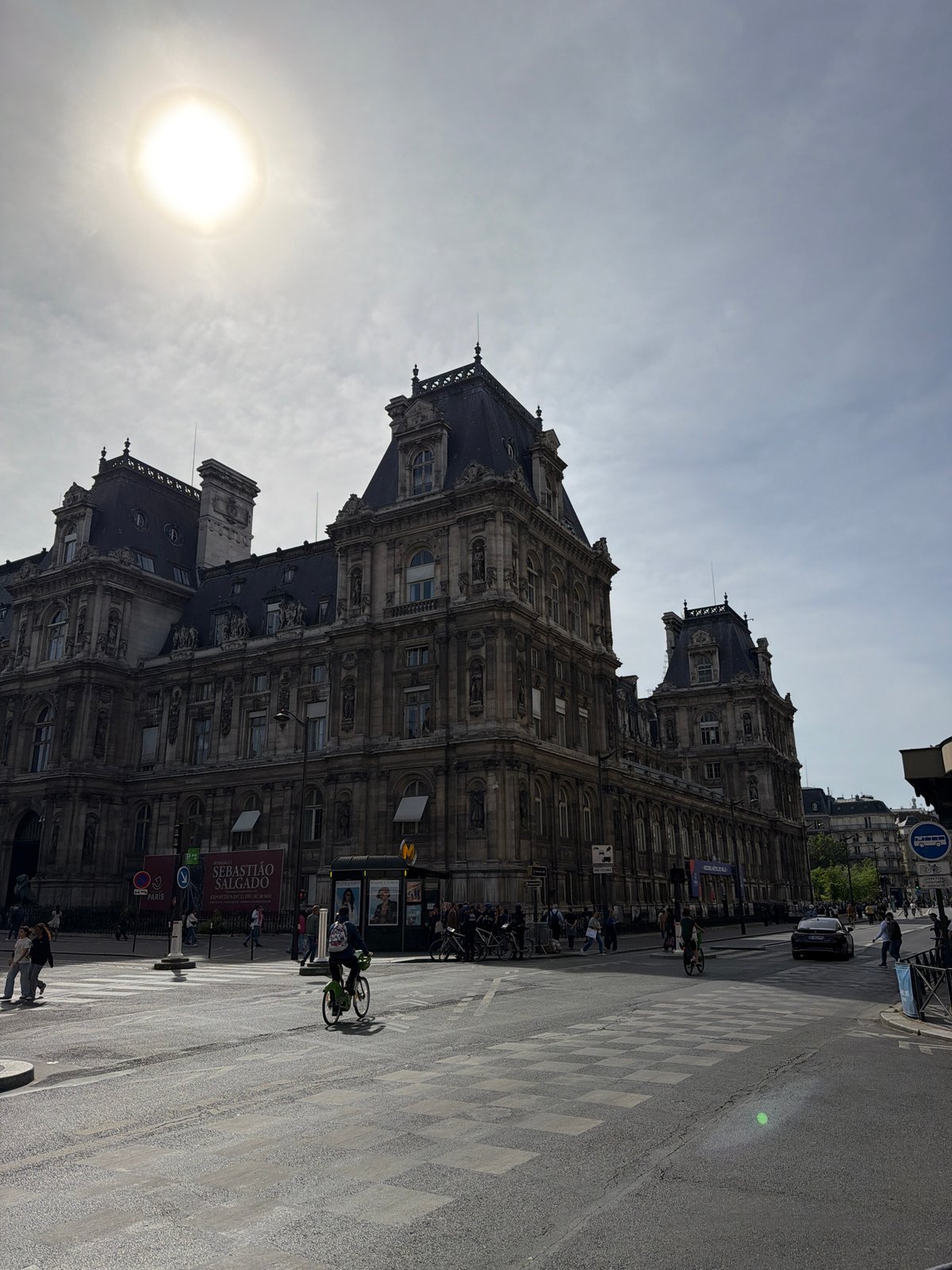 Historic Parisian building photographed under dramatic overcast afternoon sky