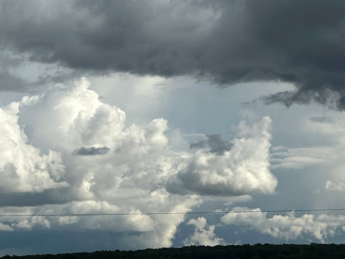 Storm clouds gather over urban landscape during afternoon