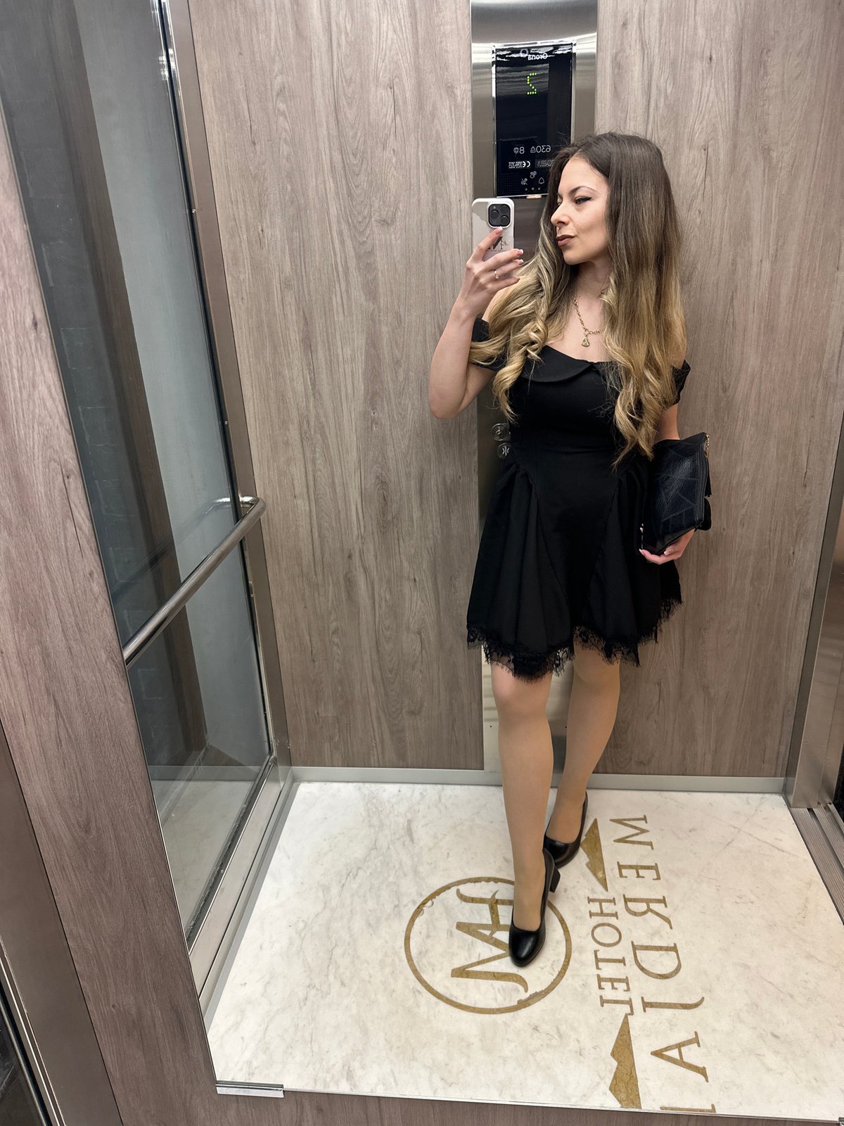 Woman photographs herself in elevator, poses for portrait in Bulgaria