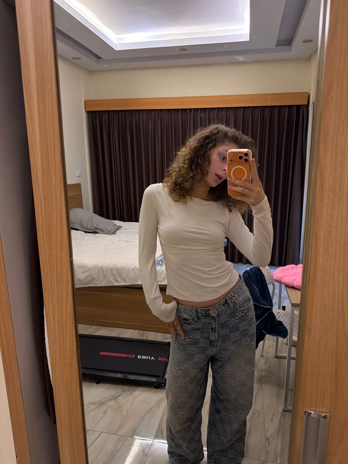 Woman takes mirror selfies in North Kuta hotel room