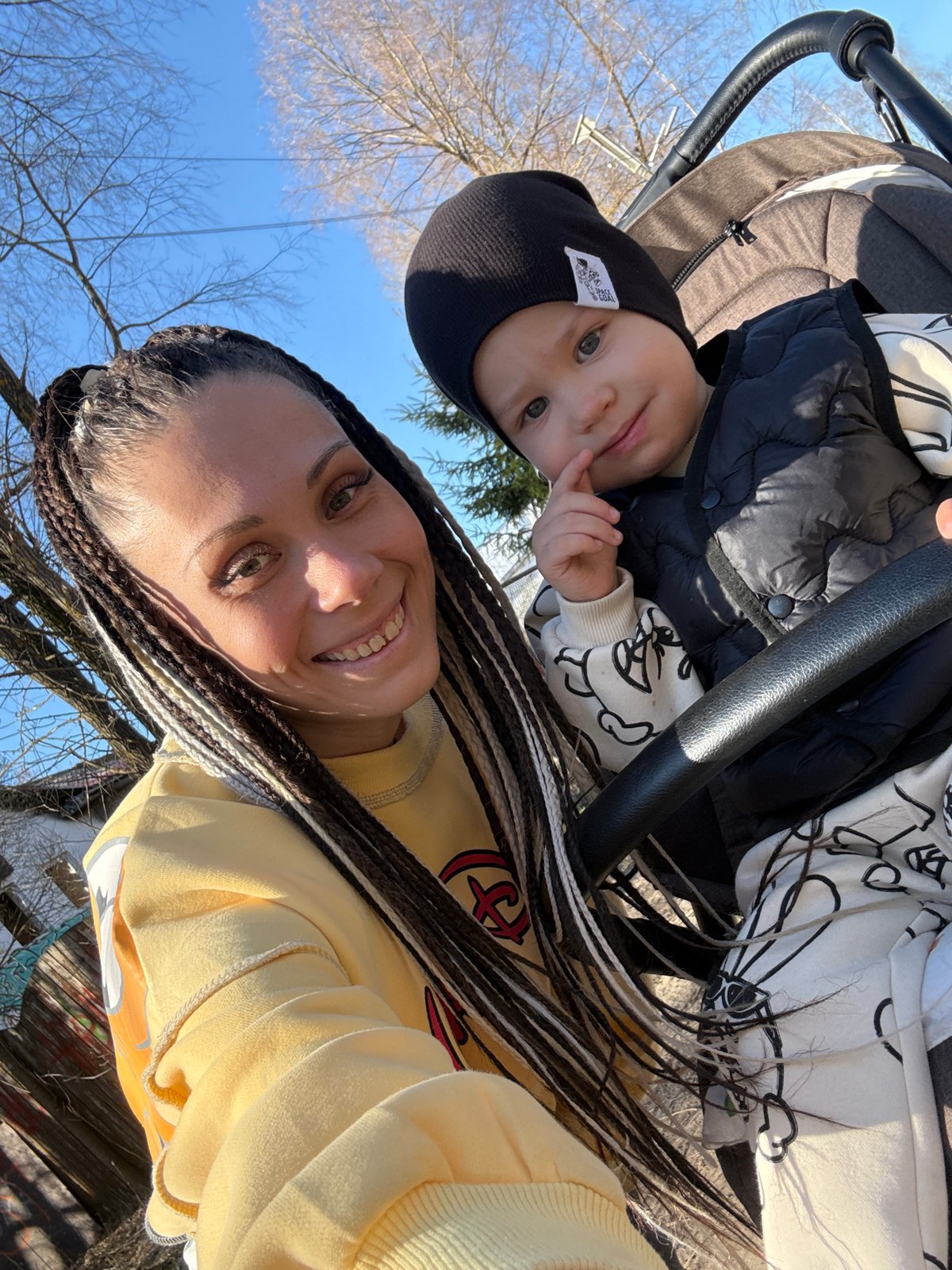 Woman takes selfies with baby during stroller outing