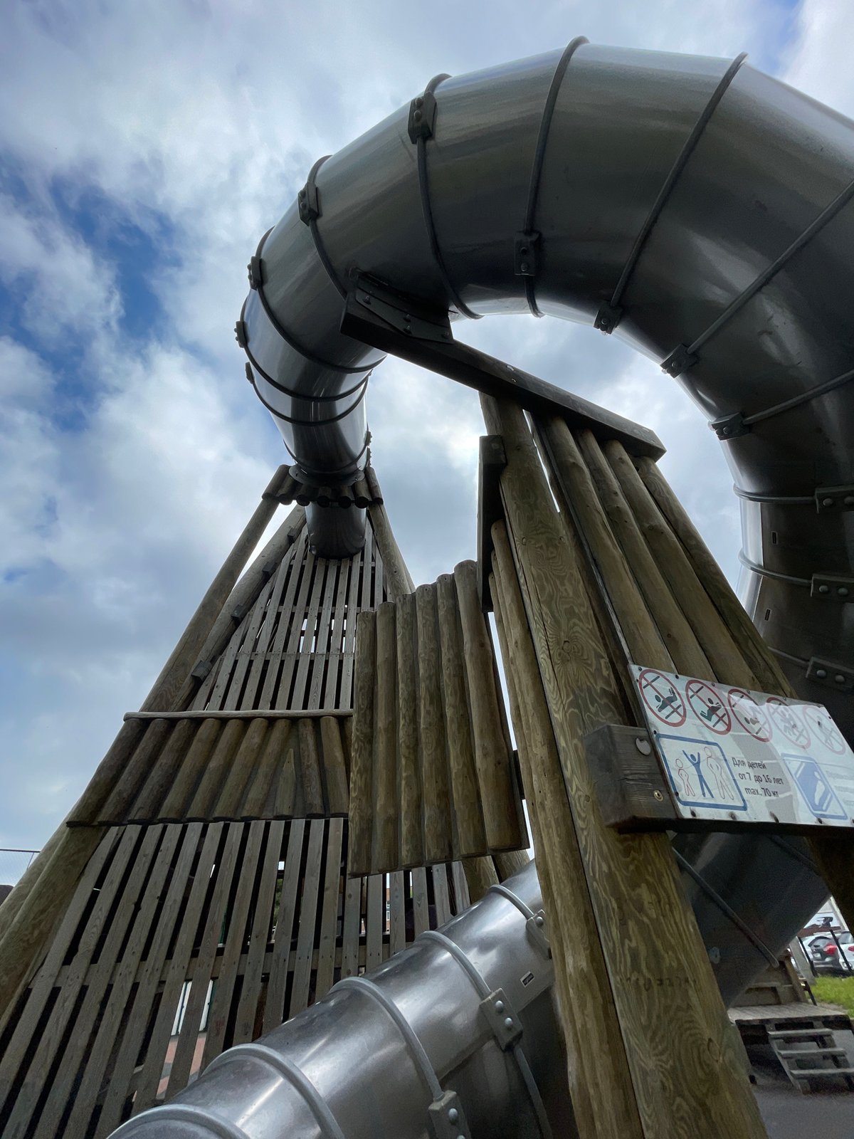 Family playtime documented at Izhevsk playground with tube slide