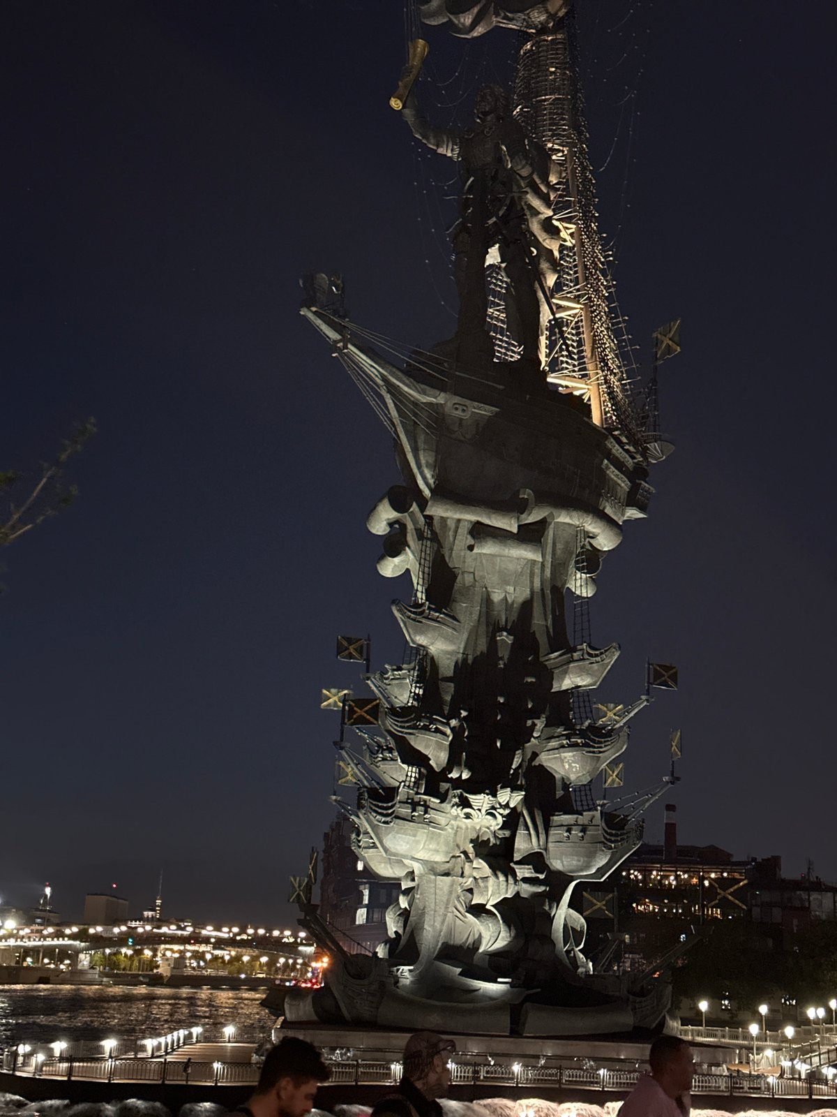 Evening gathering at illuminated Peter the Great Monument in Moscow