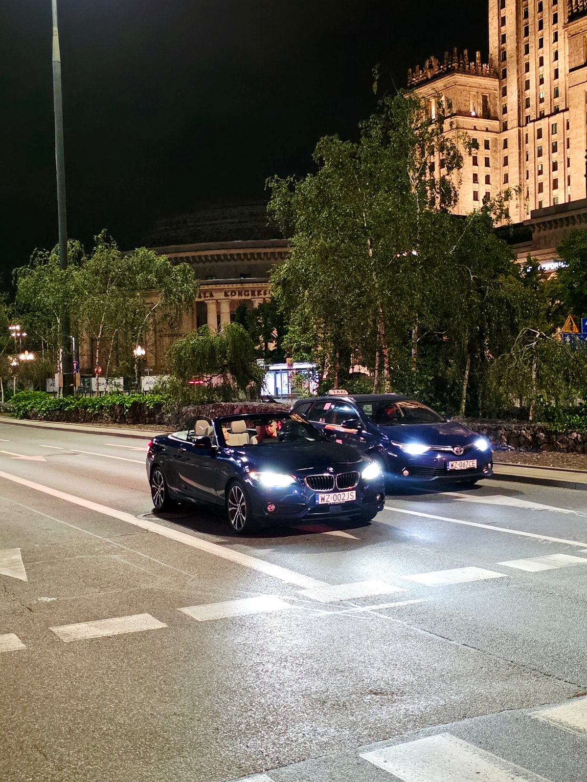 Night drive through Warsaw's lit-up city center