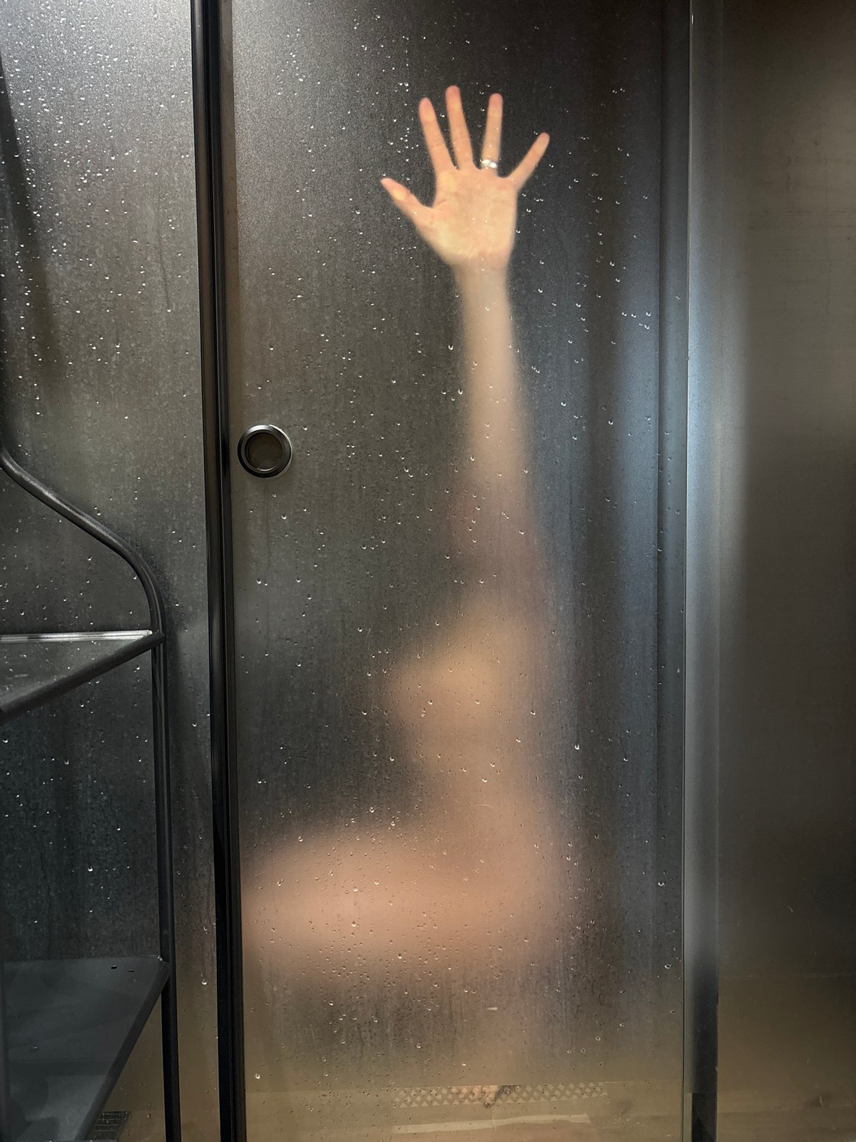 Morning shower routine captured behind steamed glass in Chaikovsky