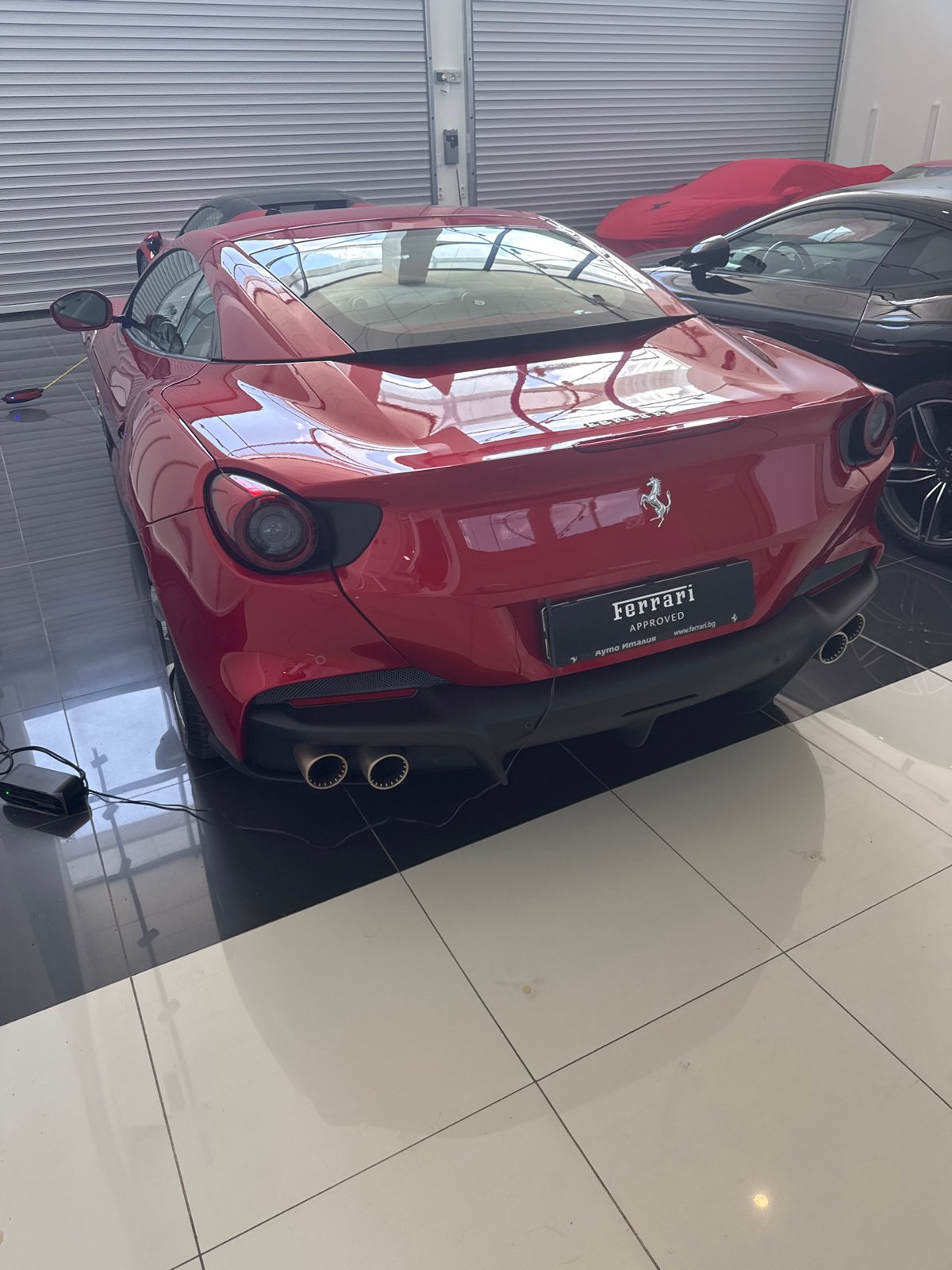Luxury car showroom with red Ferrari observed in Sofia