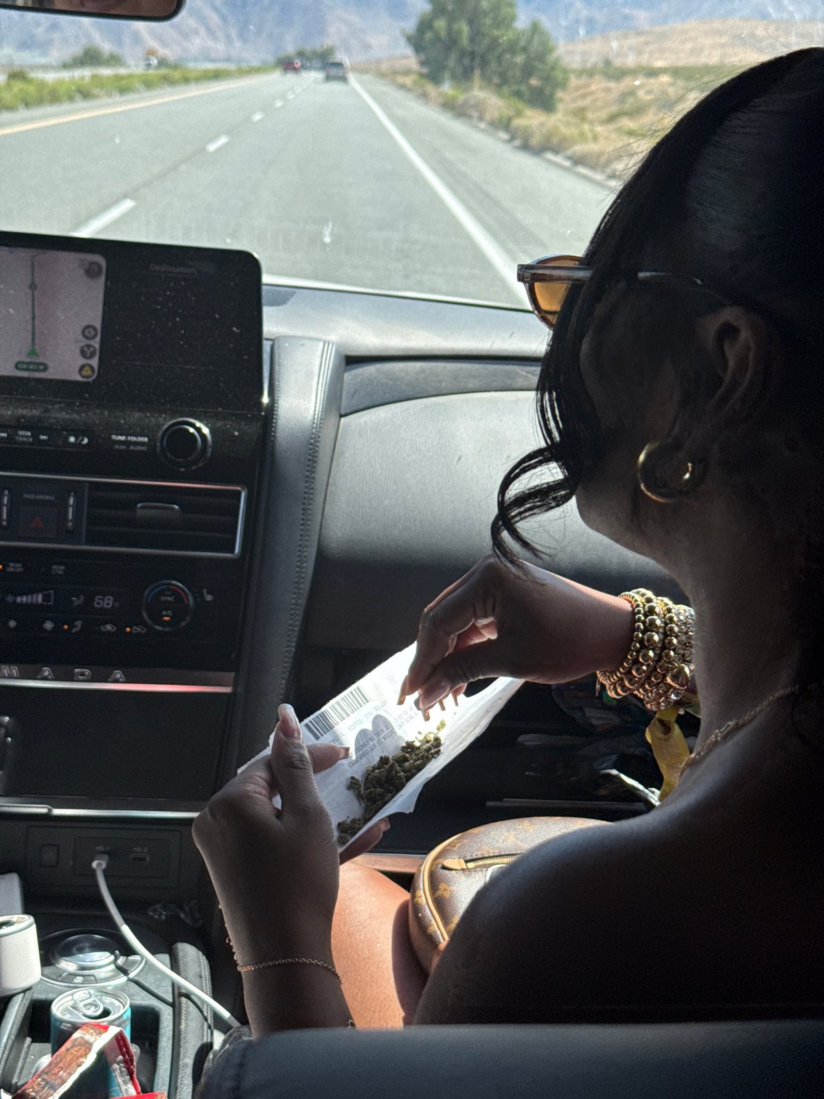 Woman examines bag contents in vehicle on Desert Hot Springs highway