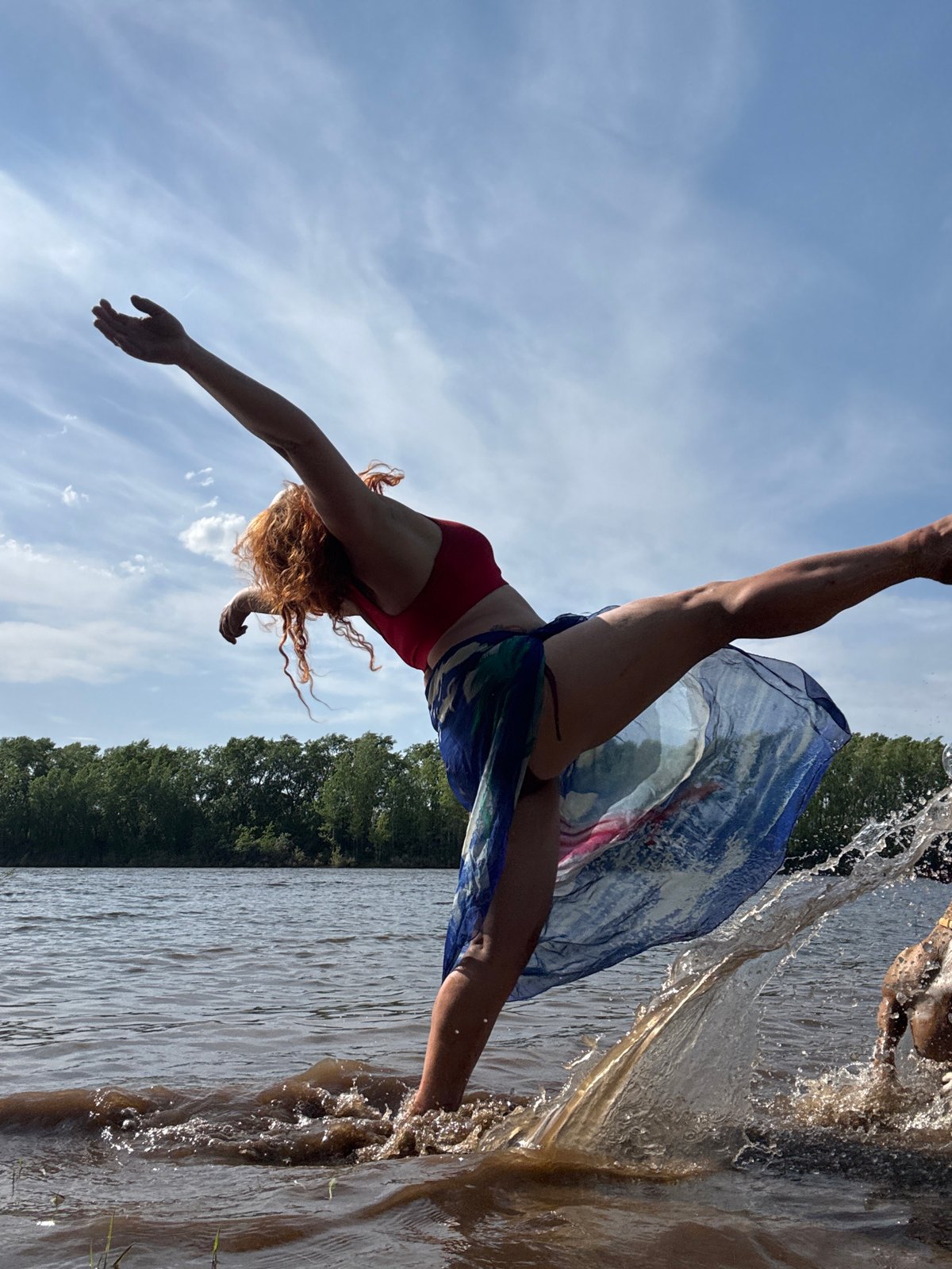 Woman dives into water wearing scarf in Chaikovsky