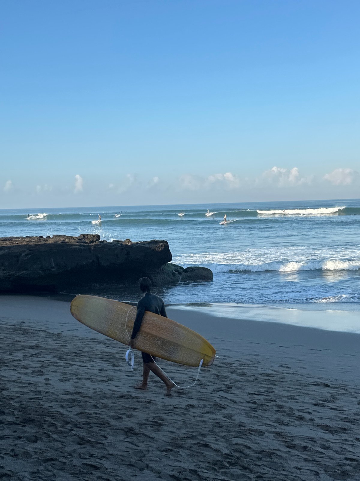 Surfers, shops, and beach life along North Kuta's shoreline