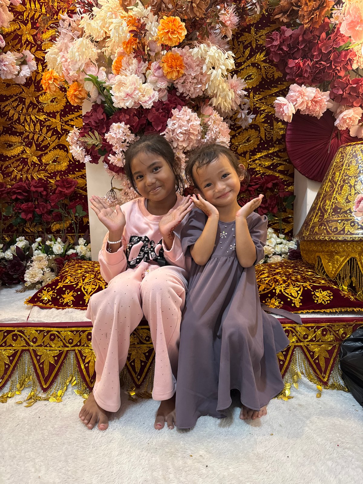 Posed portraits in front of ornate decorative backdrops