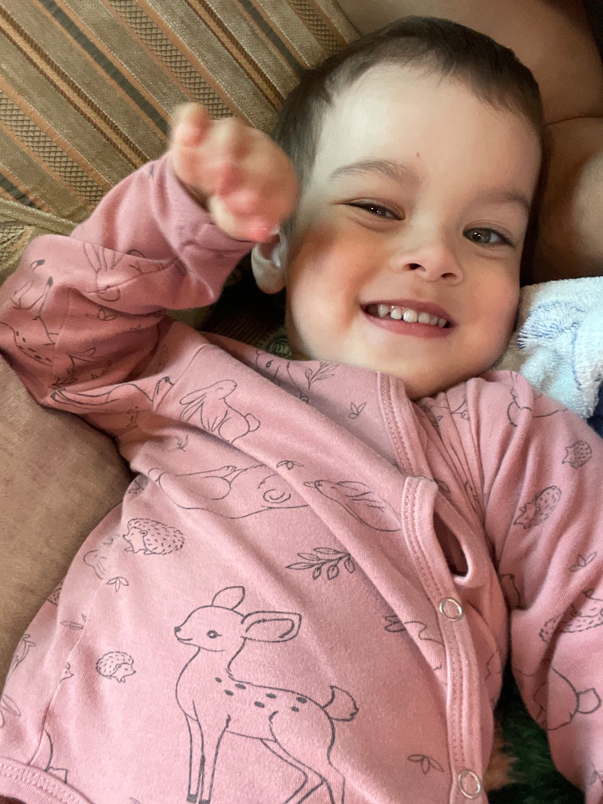Child in pink pajamas relaxing indoors in Zav'yalovo, Russia