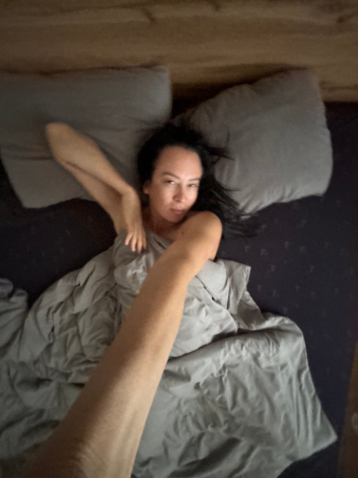 Woman takes morning selfies with dog in Chaikovsky bedroom