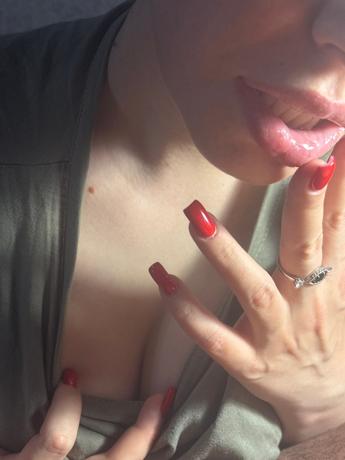 Close-up series: red nails, green top, pink drink