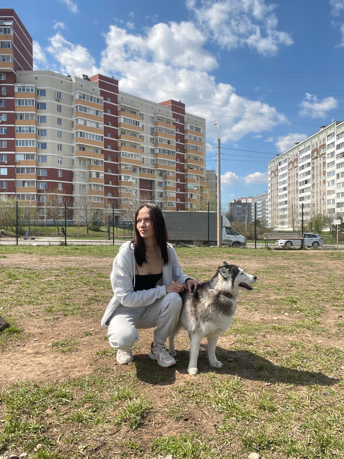 Woman with husky dog enjoys sunny morning in Izhevsk park